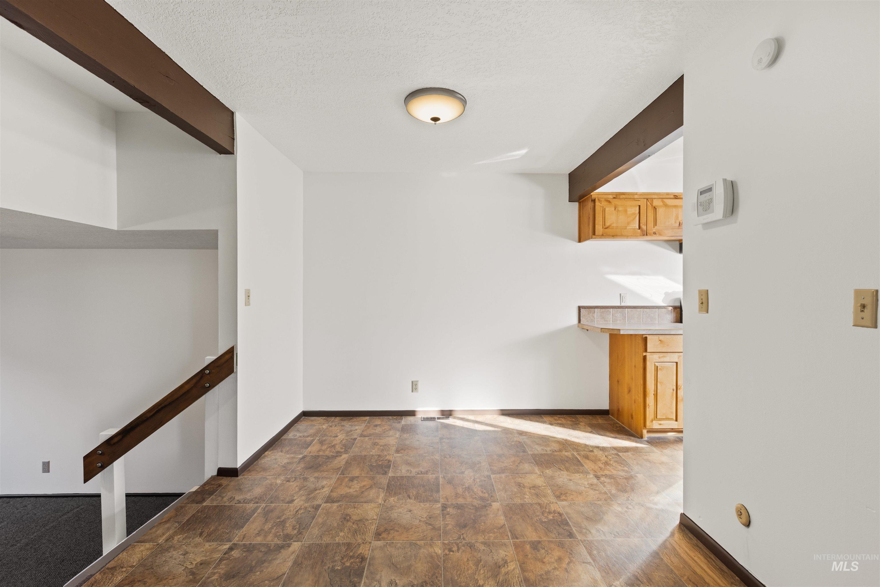Hallway with stone finish floors and a textured ceiling