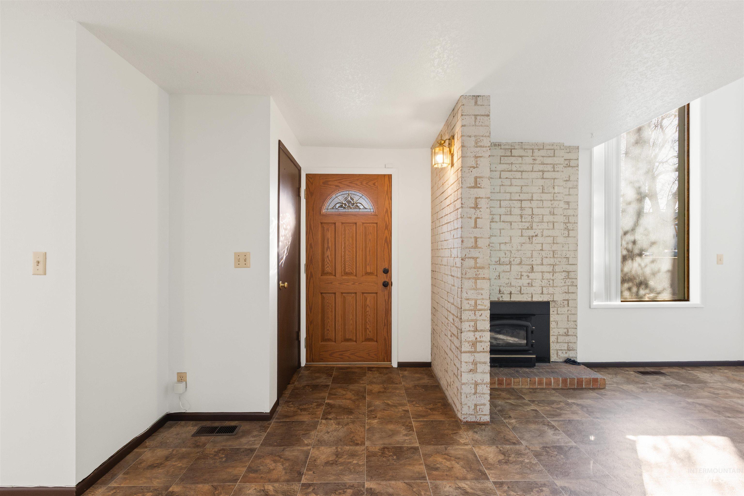 Entryway with baseboards and stone finish floors