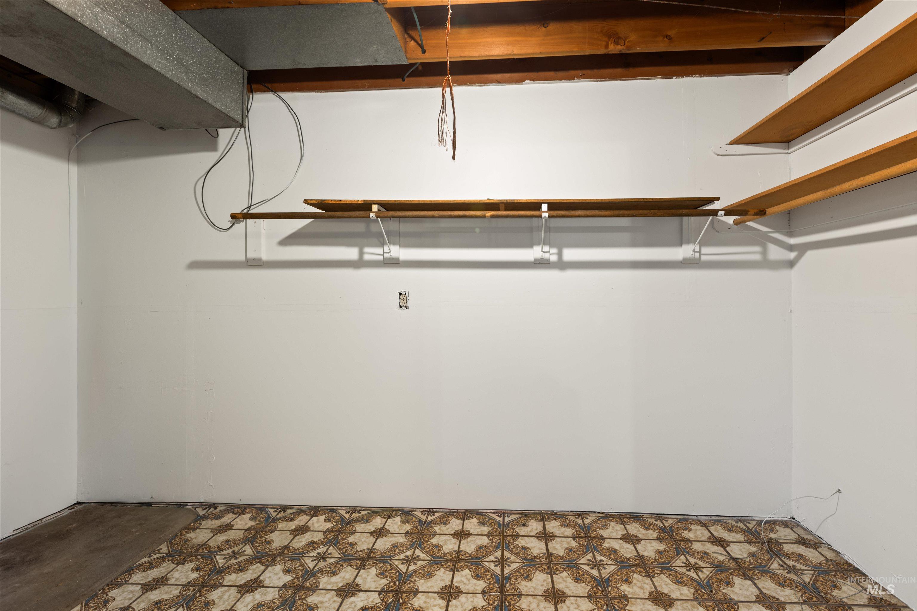 Walk in closet with tile patterned floors