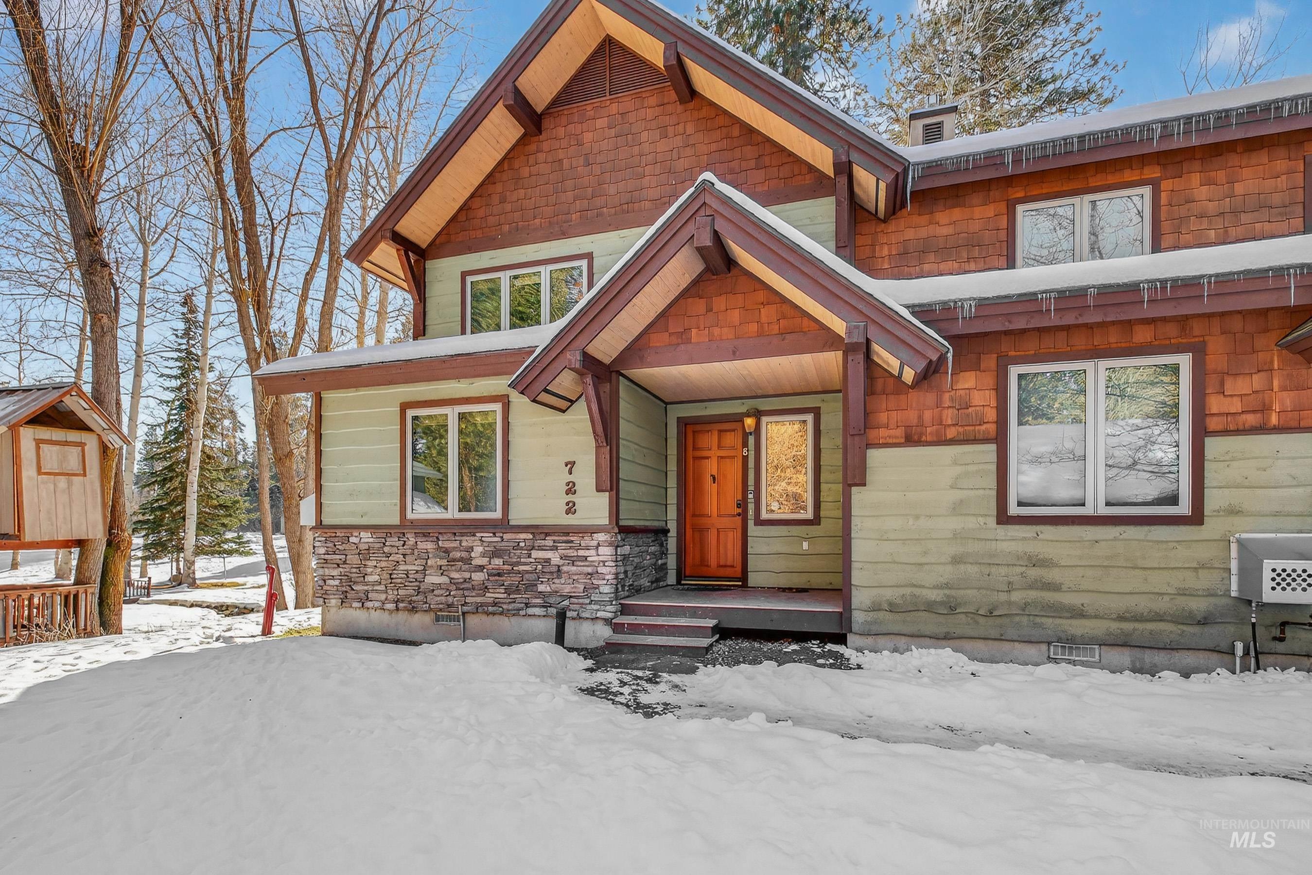 View of front of home featuring crawl space and stone siding