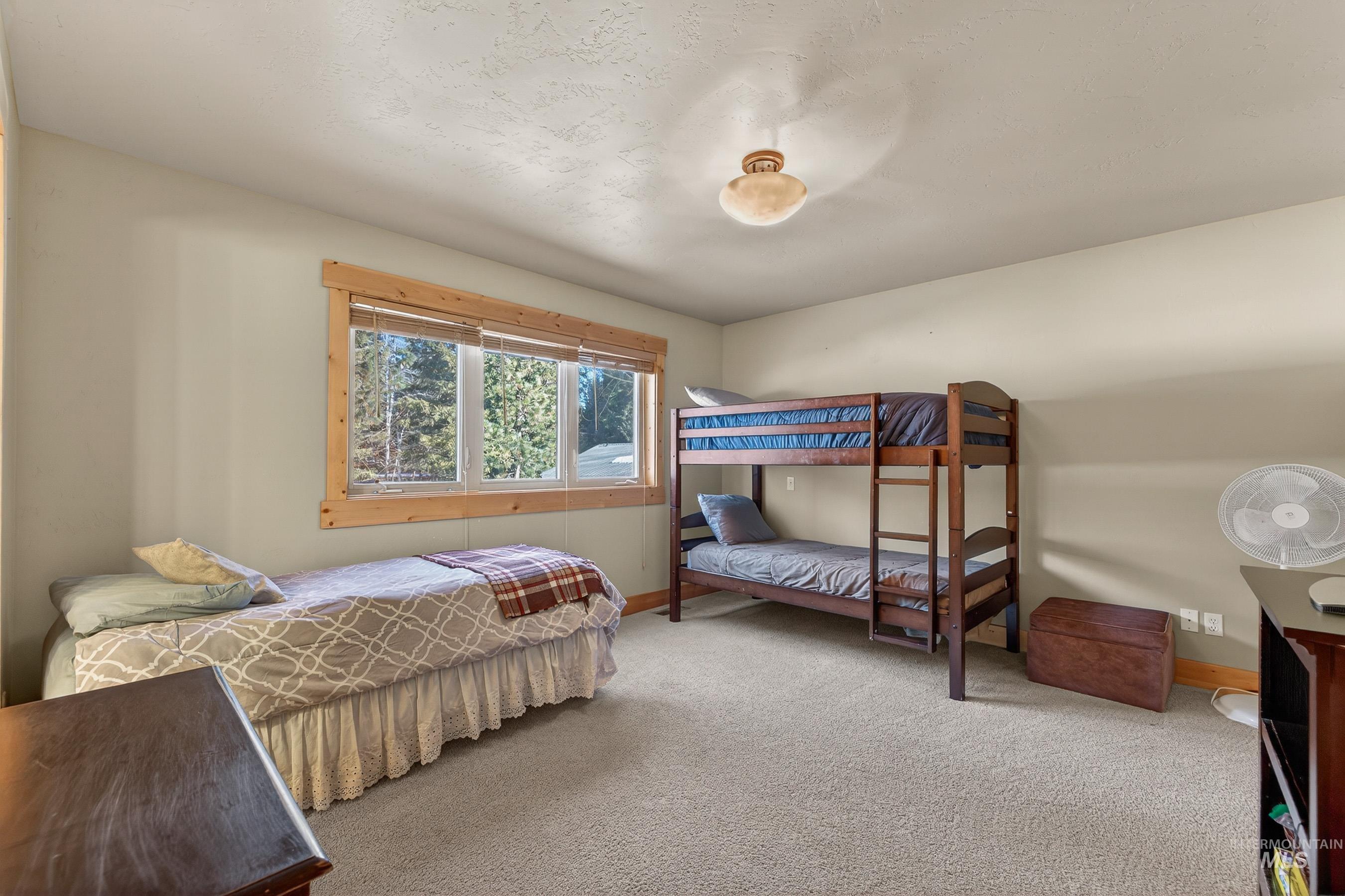 Bedroom with carpet floors and baseboards