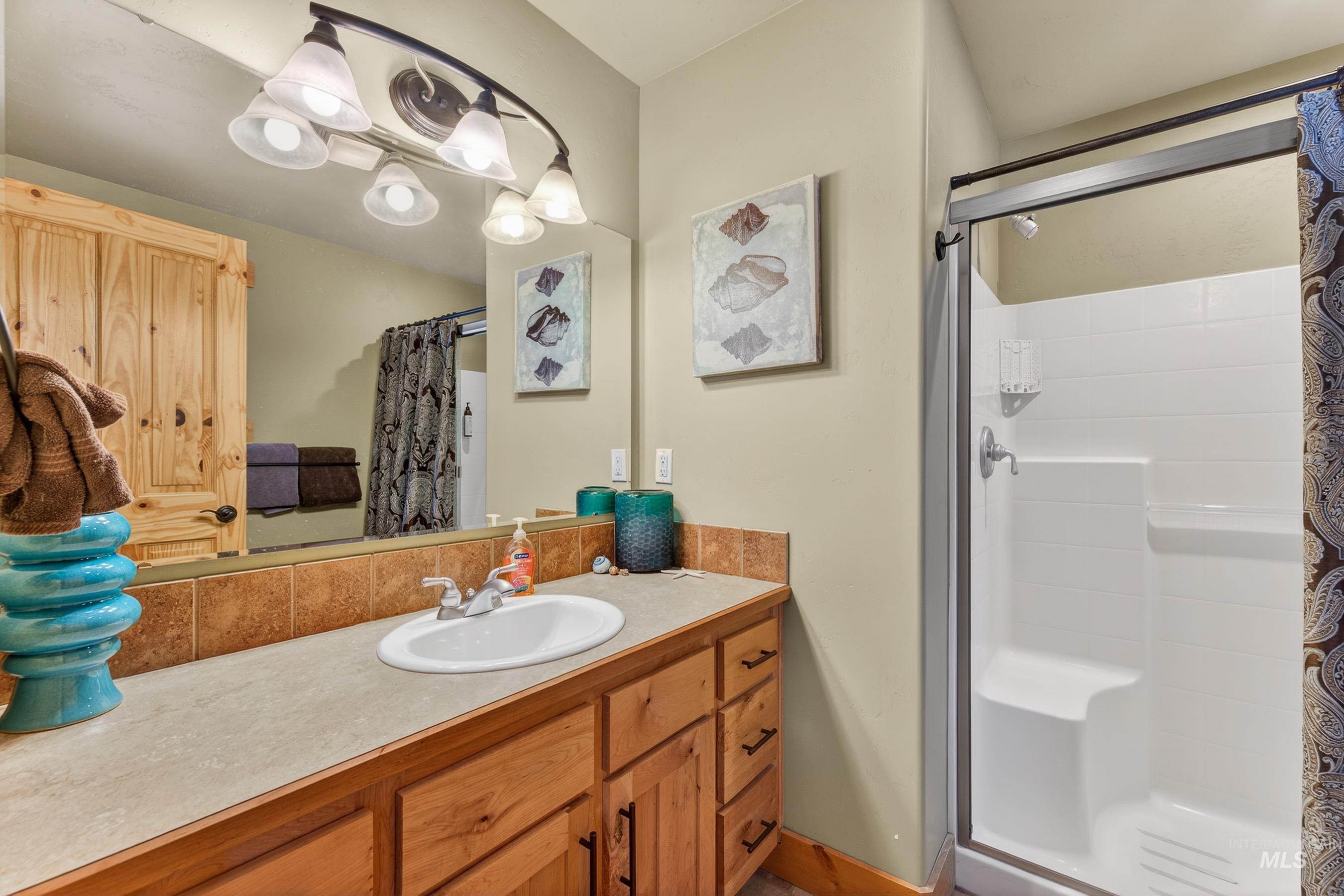 Bathroom with a stall shower and vanity