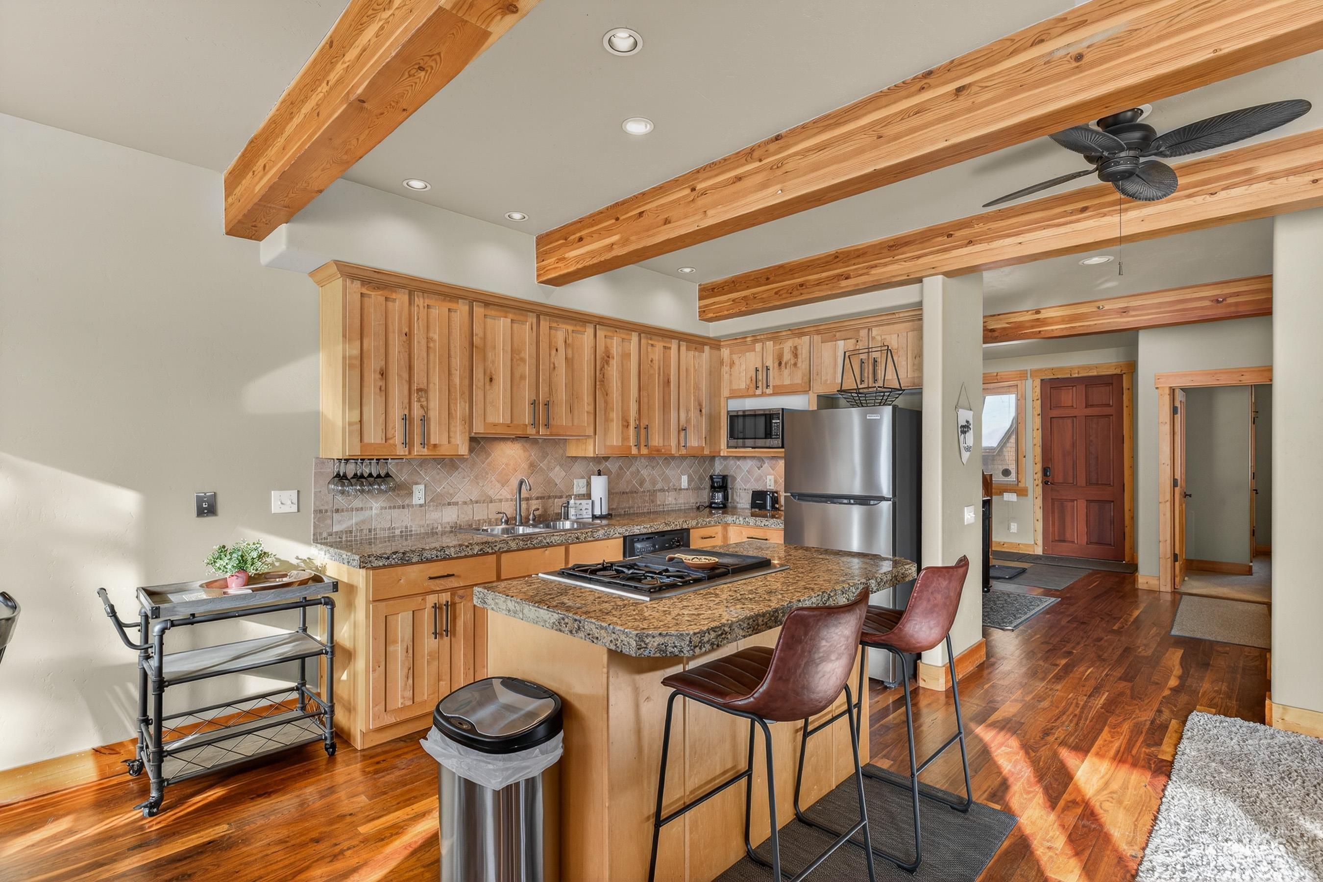 Kitchen featuring recessed lighting, a kitchen breakfast bar, a kitchen island, decorative backsplash, and appliances with stainless steel finishes