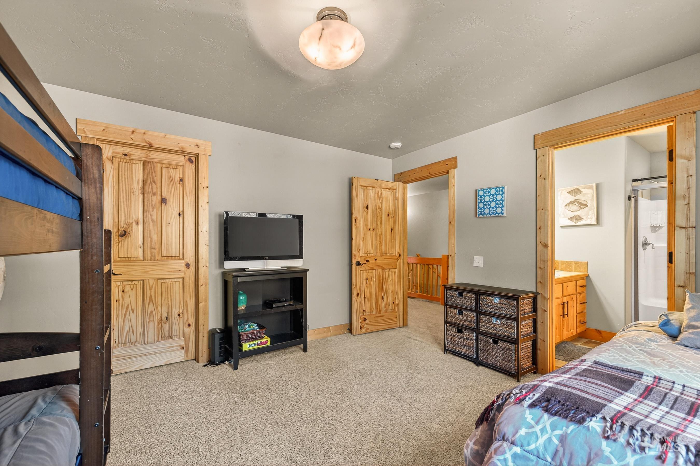 Bedroom featuring carpet and ensuite bath