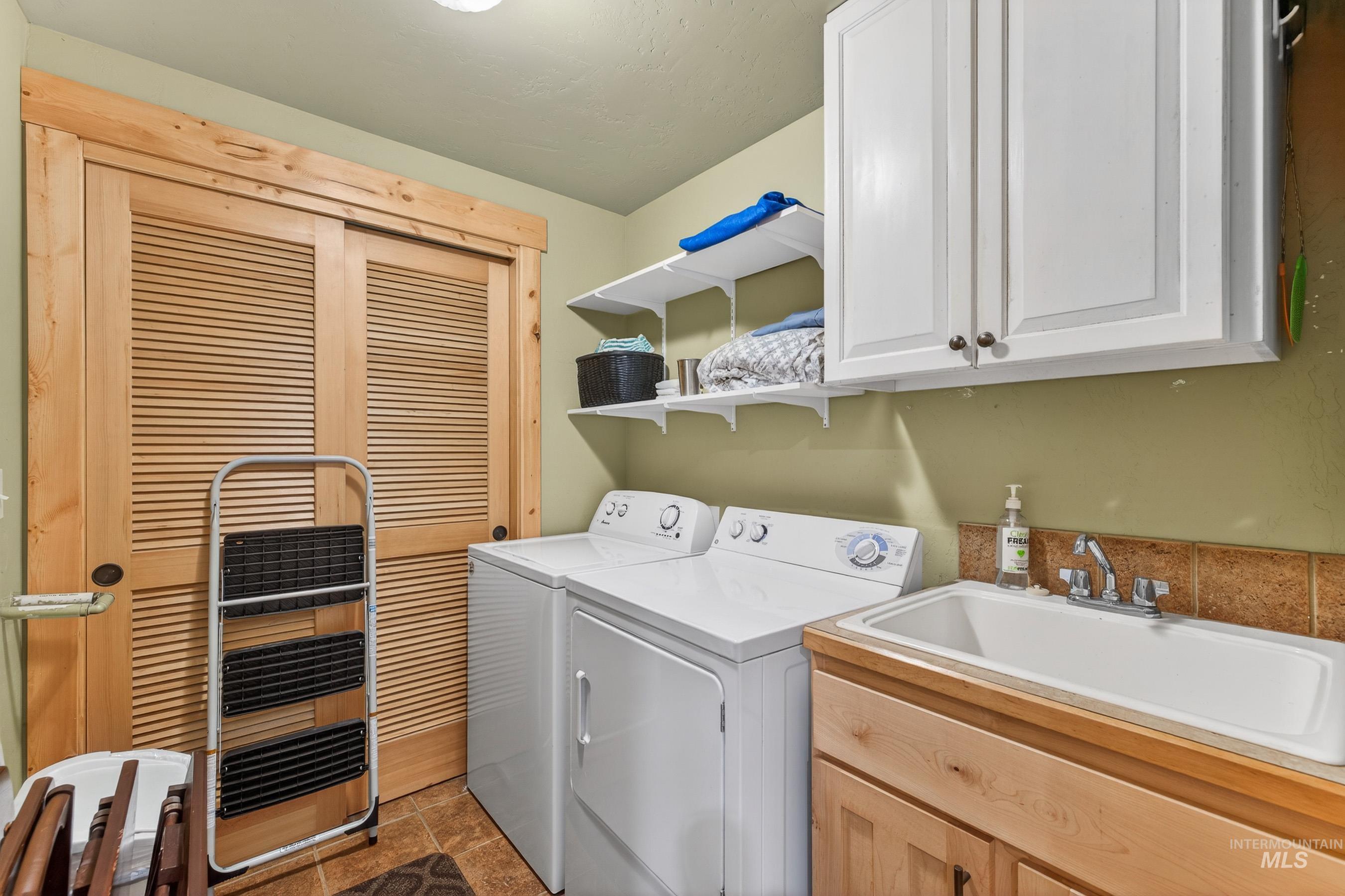 Laundry area featuring washer and dryer and cabinet space