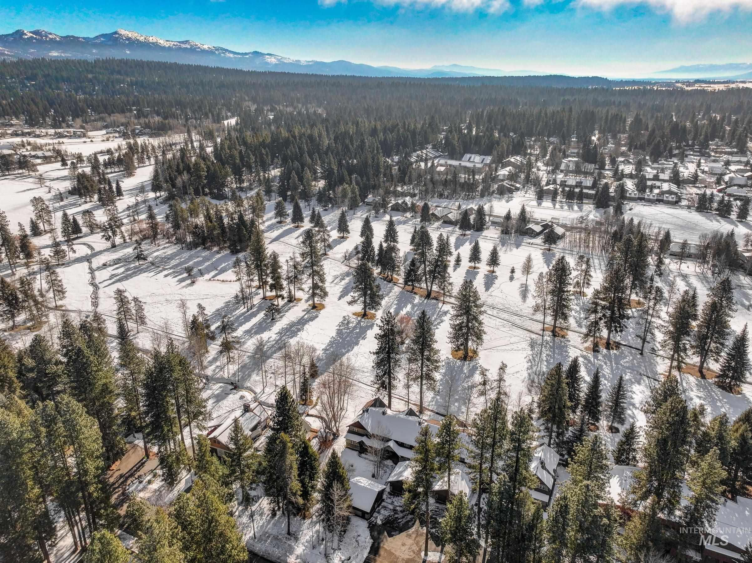 Aerial overview of property's location featuring a mountainous background