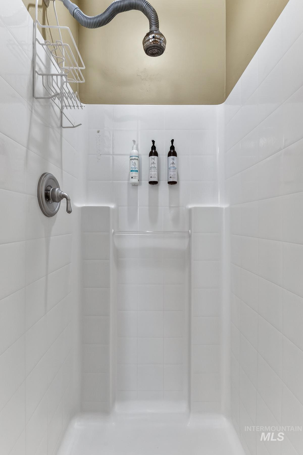 Full bath featuring a tile shower