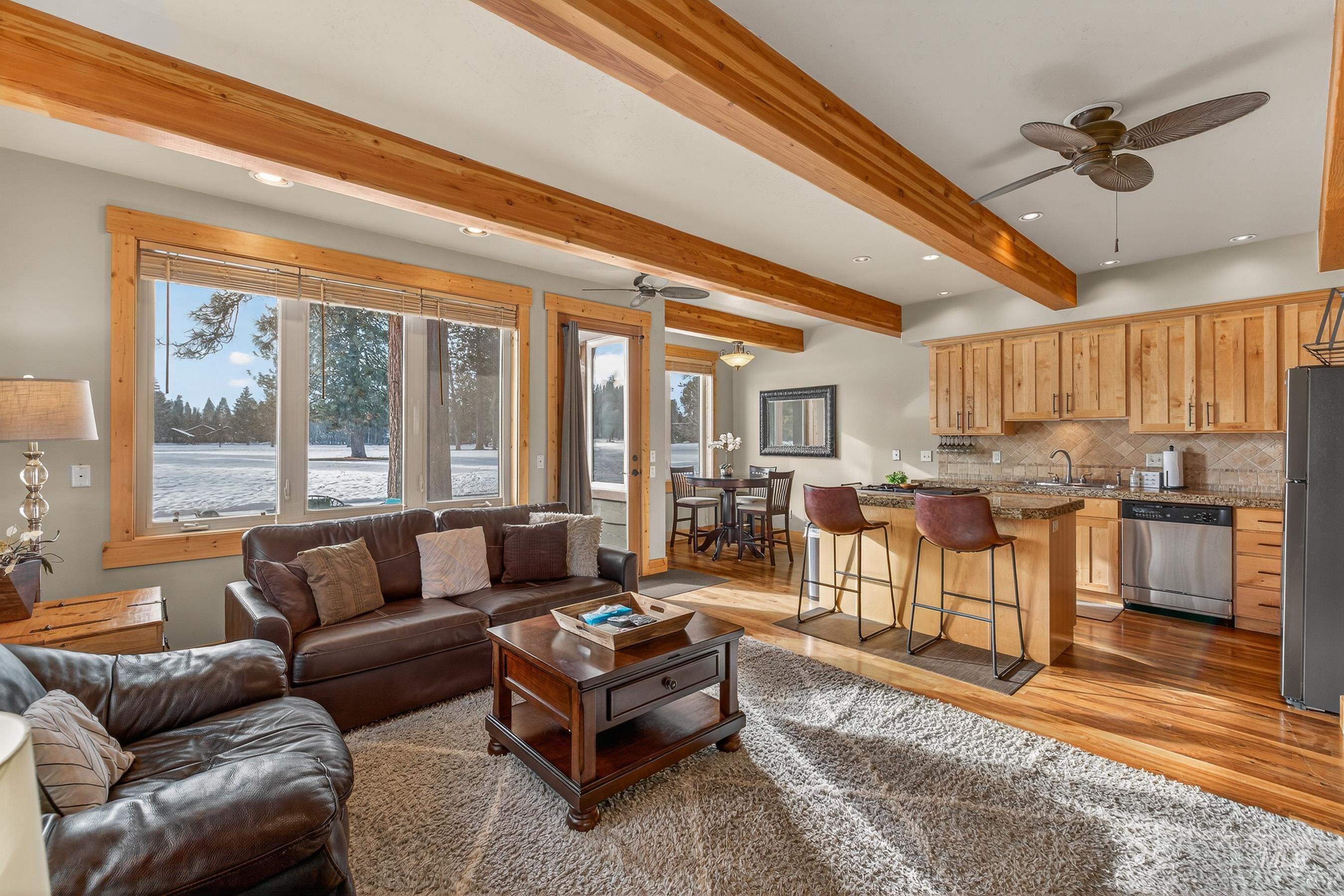 Living room featuring a ceiling fan, beam ceiling, light wood-style flooring, and recessed lighting