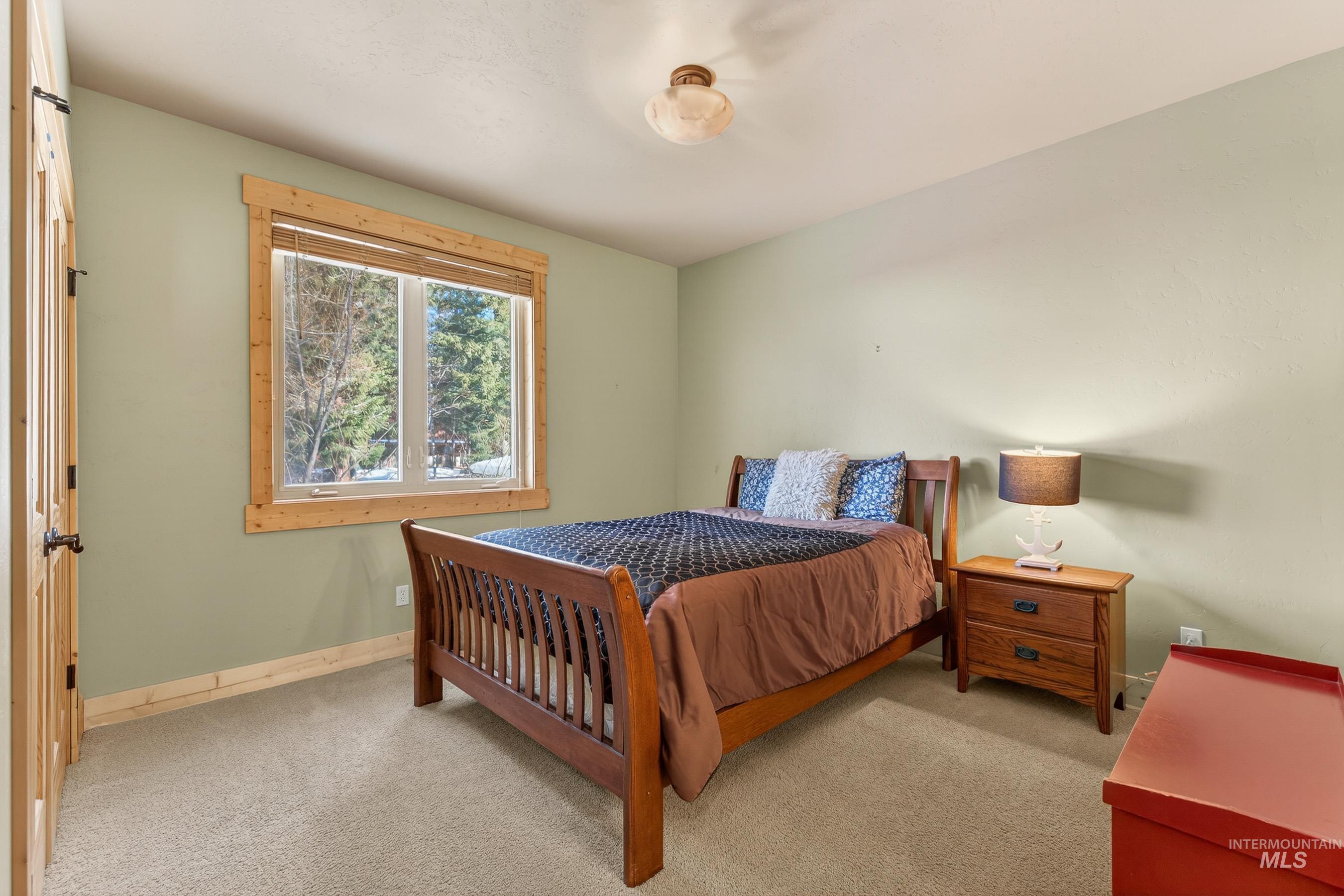 Bedroom featuring light carpet