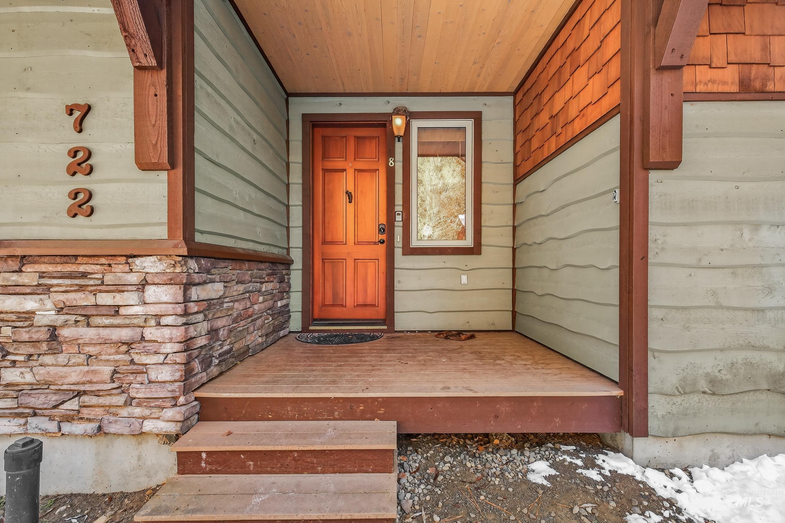 Property entrance featuring stone siding