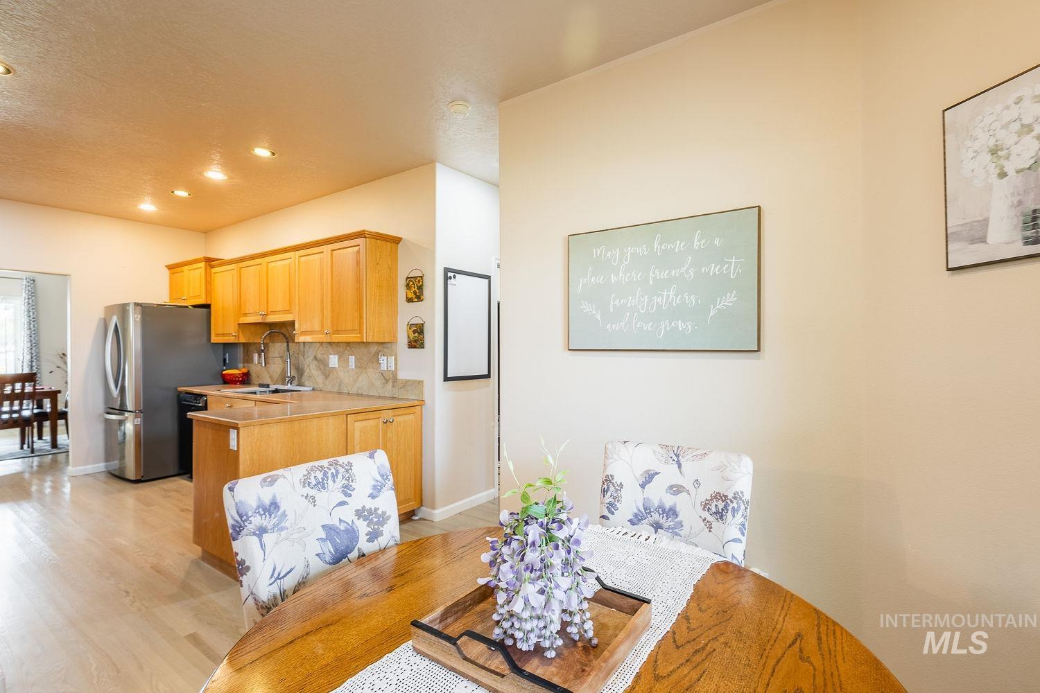 Dining room featuring light wood-style floors, a textured ceiling, and recessed lighting