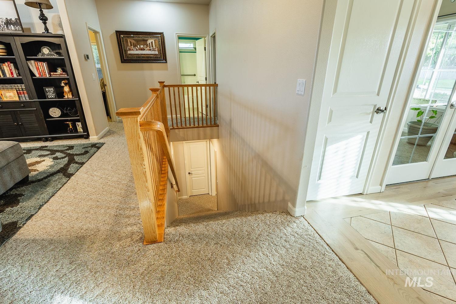 Stairway with carpet floors and baseboards