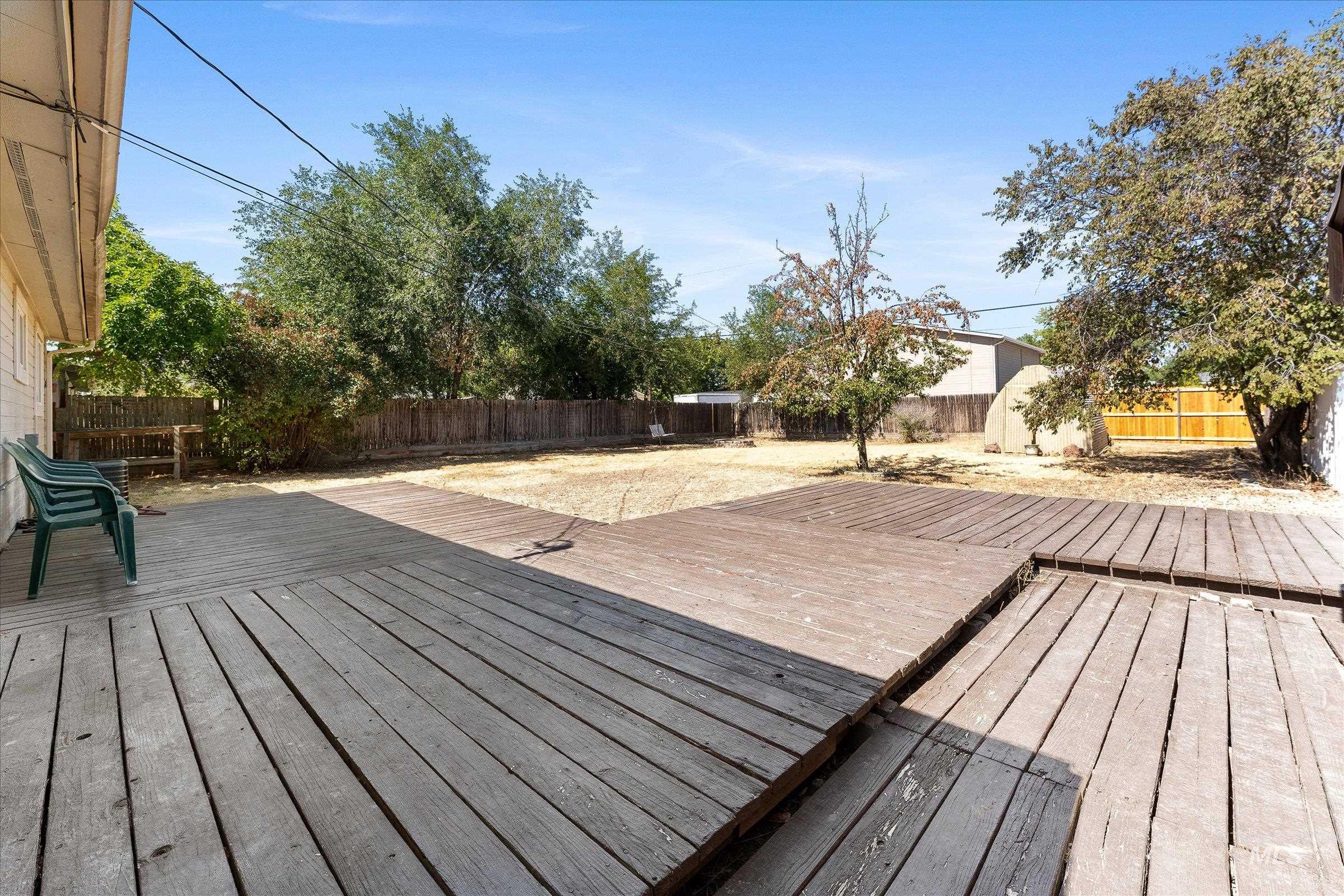 Wooden terrace featuring a fenced backyard