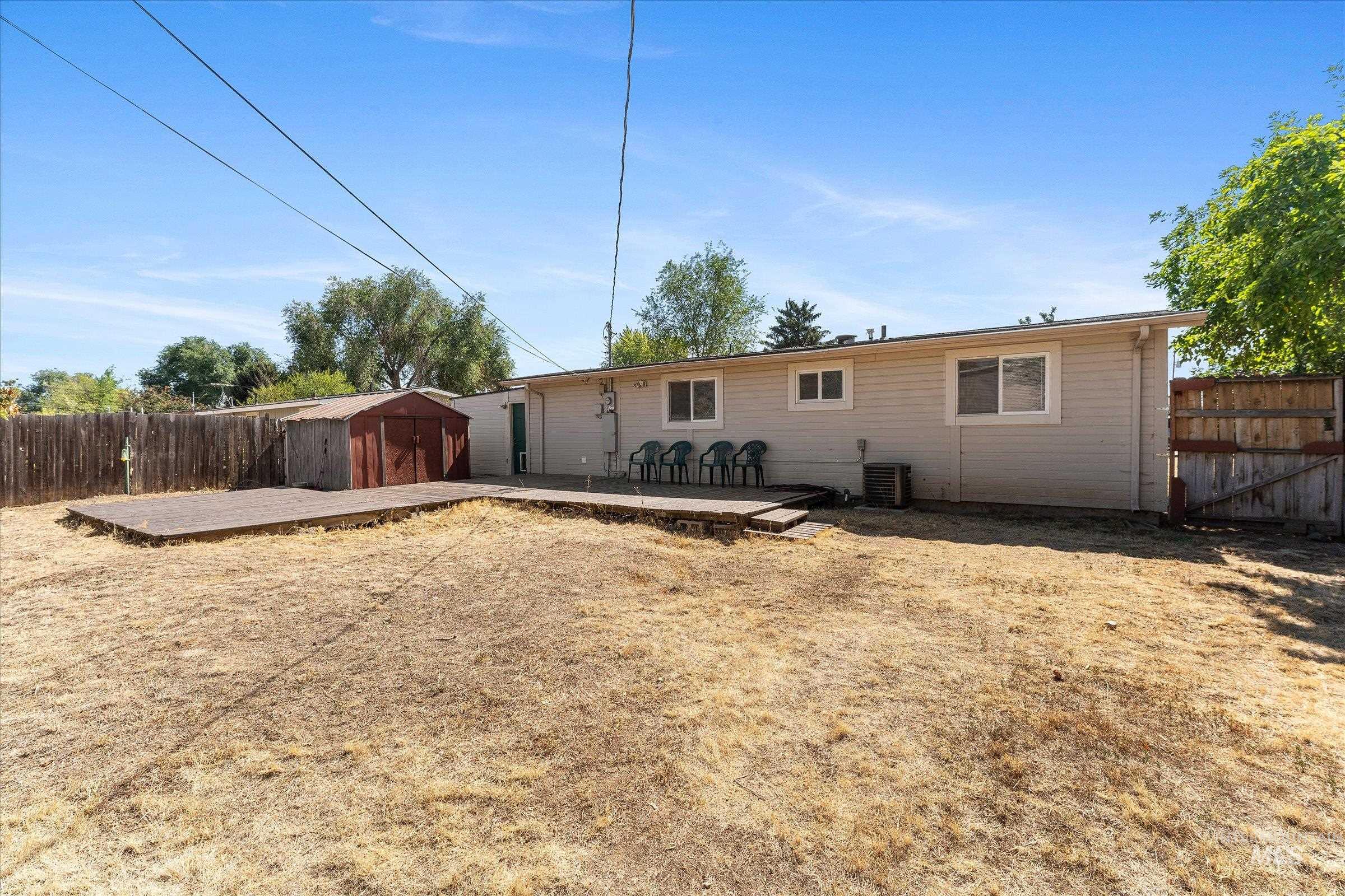 Back of house featuring a patio area and a storage shed