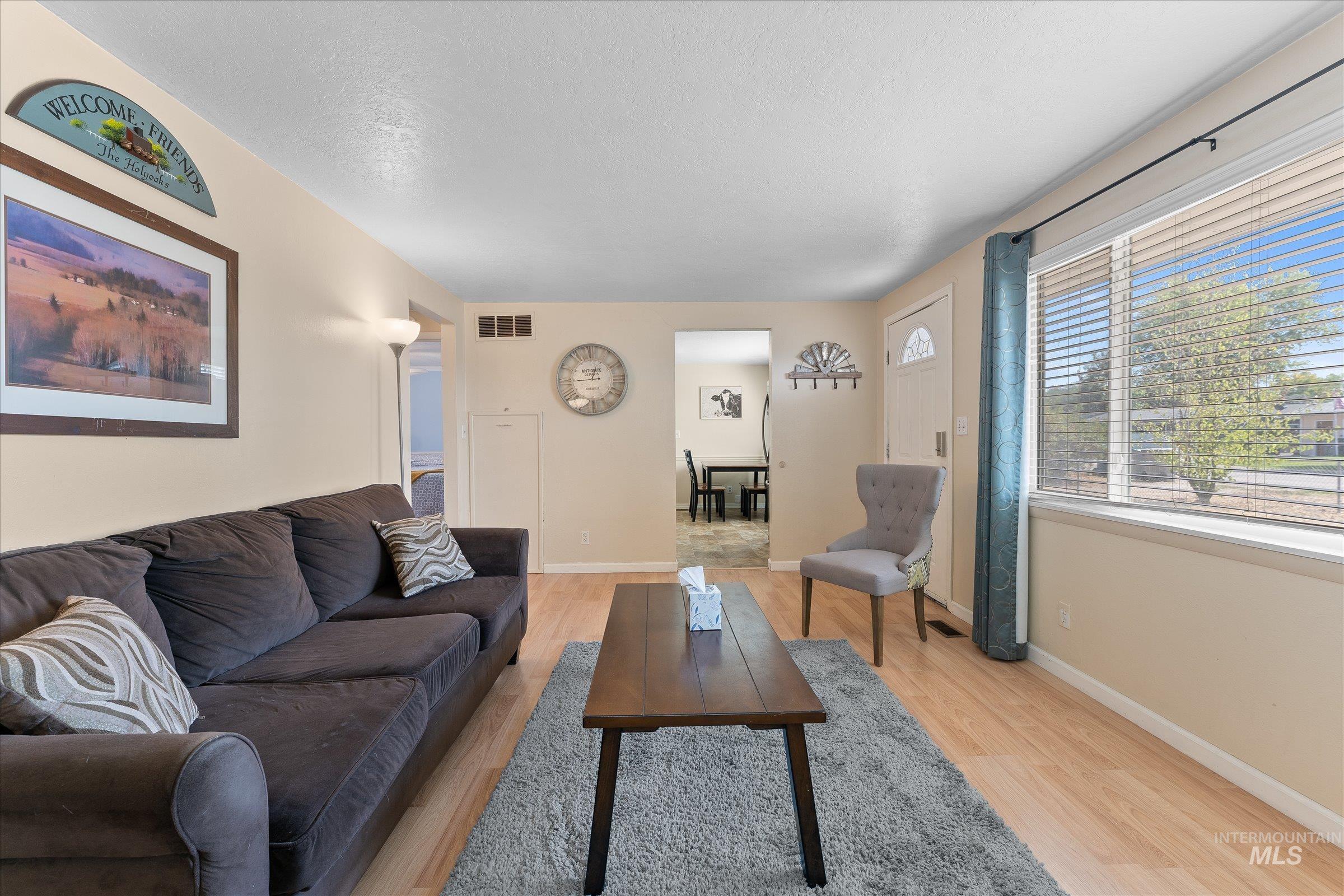 Living area featuring light wood finished floors and baseboards
