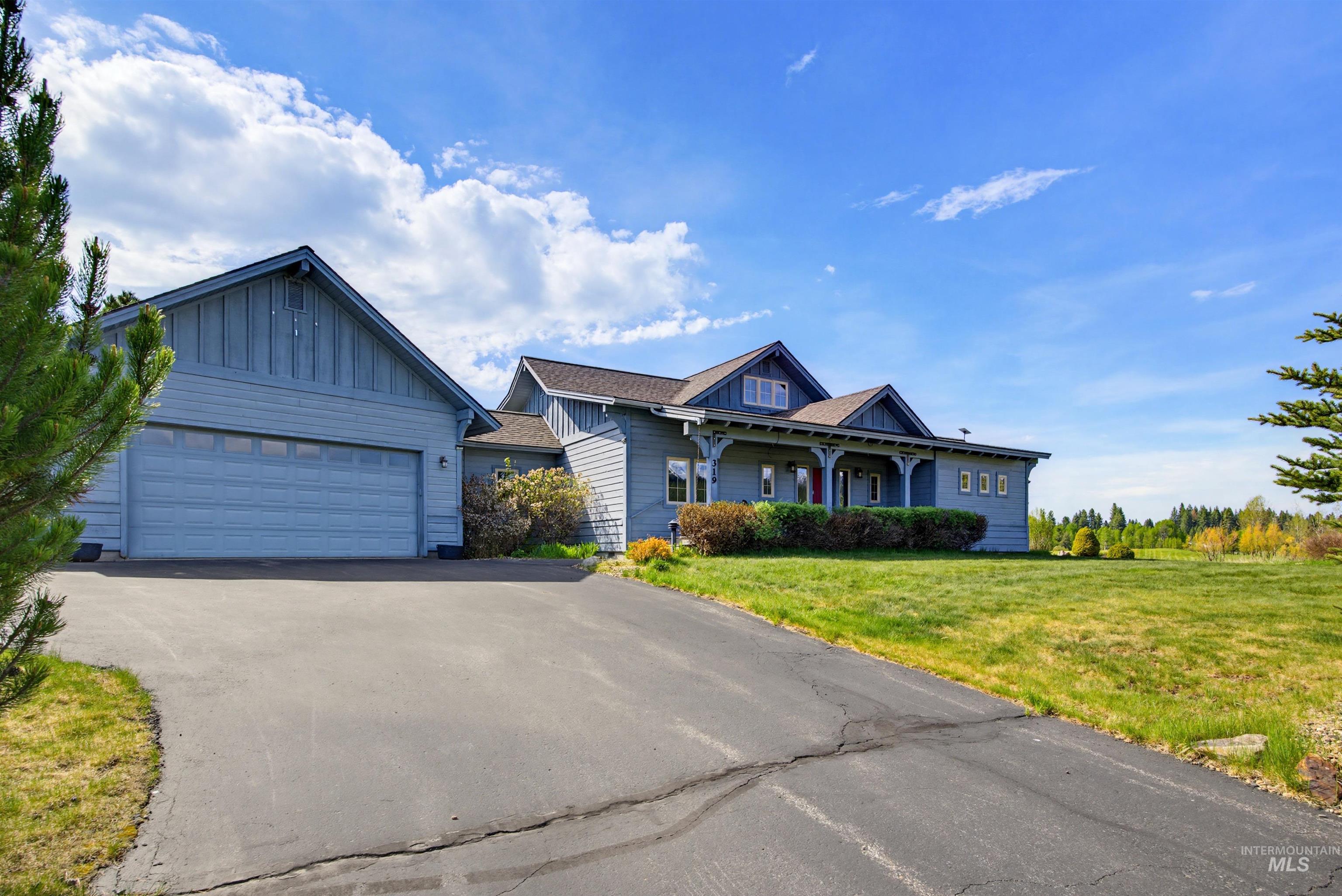 Two-car attached garage with a paved driveway