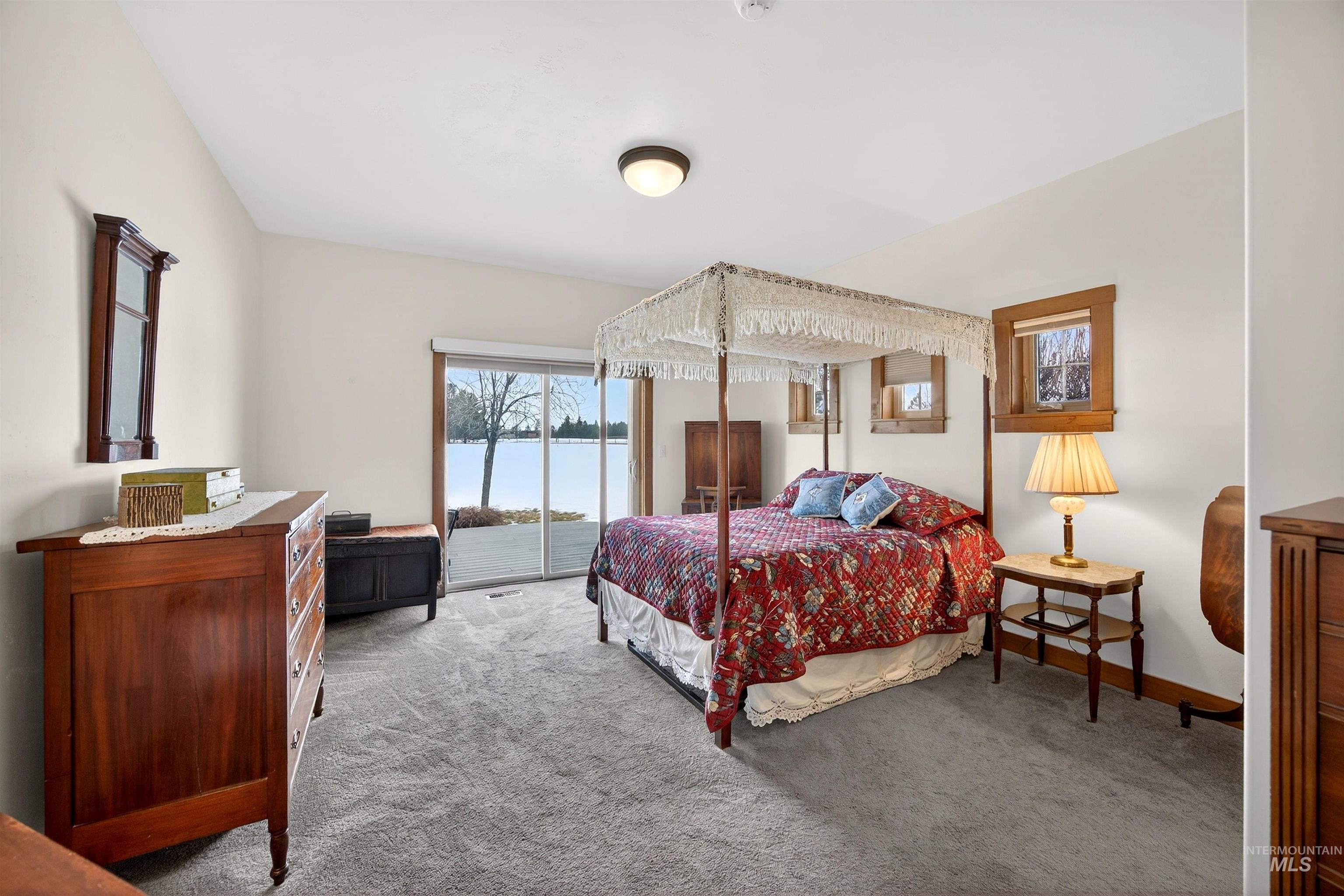 Carpeted bedroom featuring access to outside and baseboards
