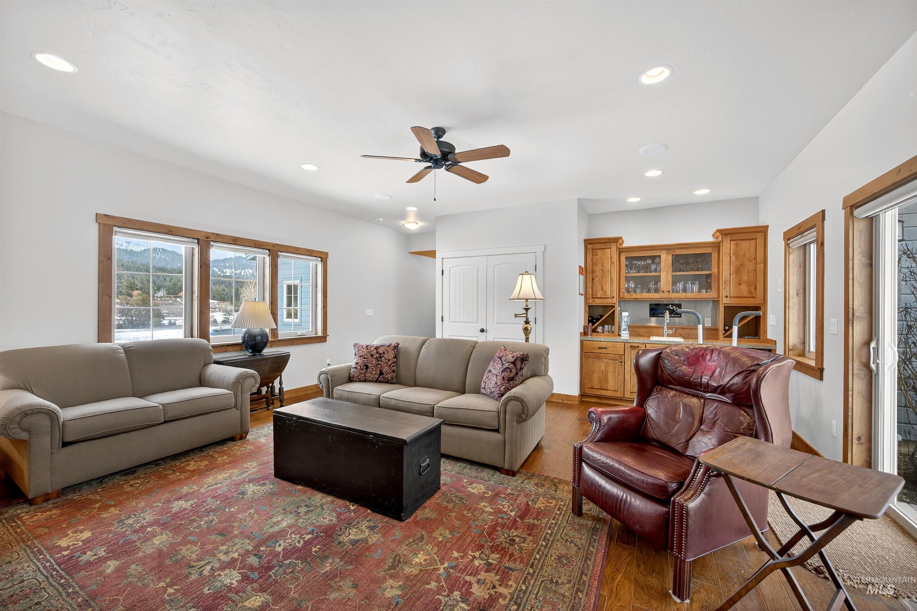 Open living area featuring wood-finish flooring and a built-in wet bar with wood cabinetry