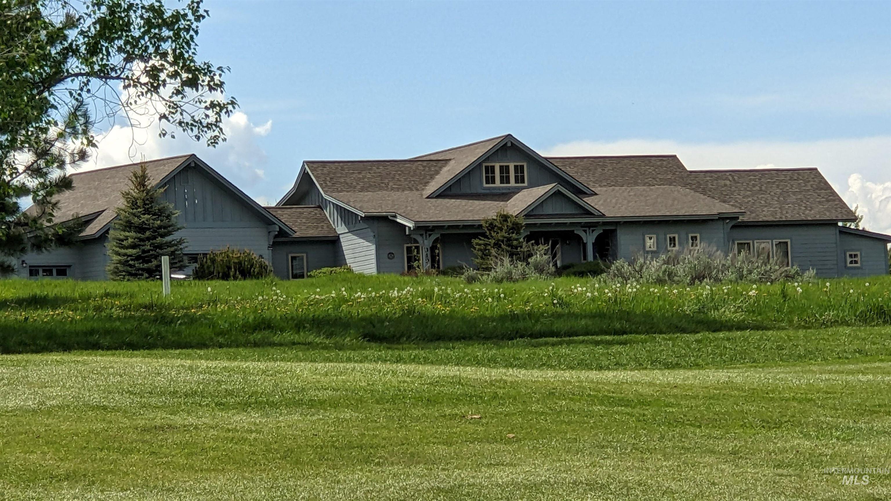 Craftsman house featuring roof with shingles, a front lawn, and covered porch