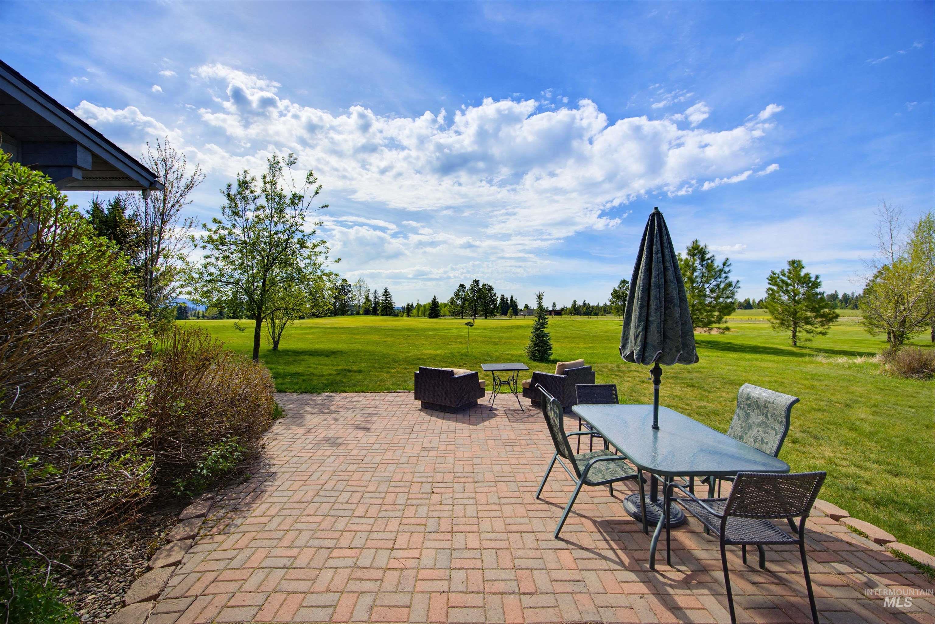 Expansive brick paver patio featuring a herringbone pattern
