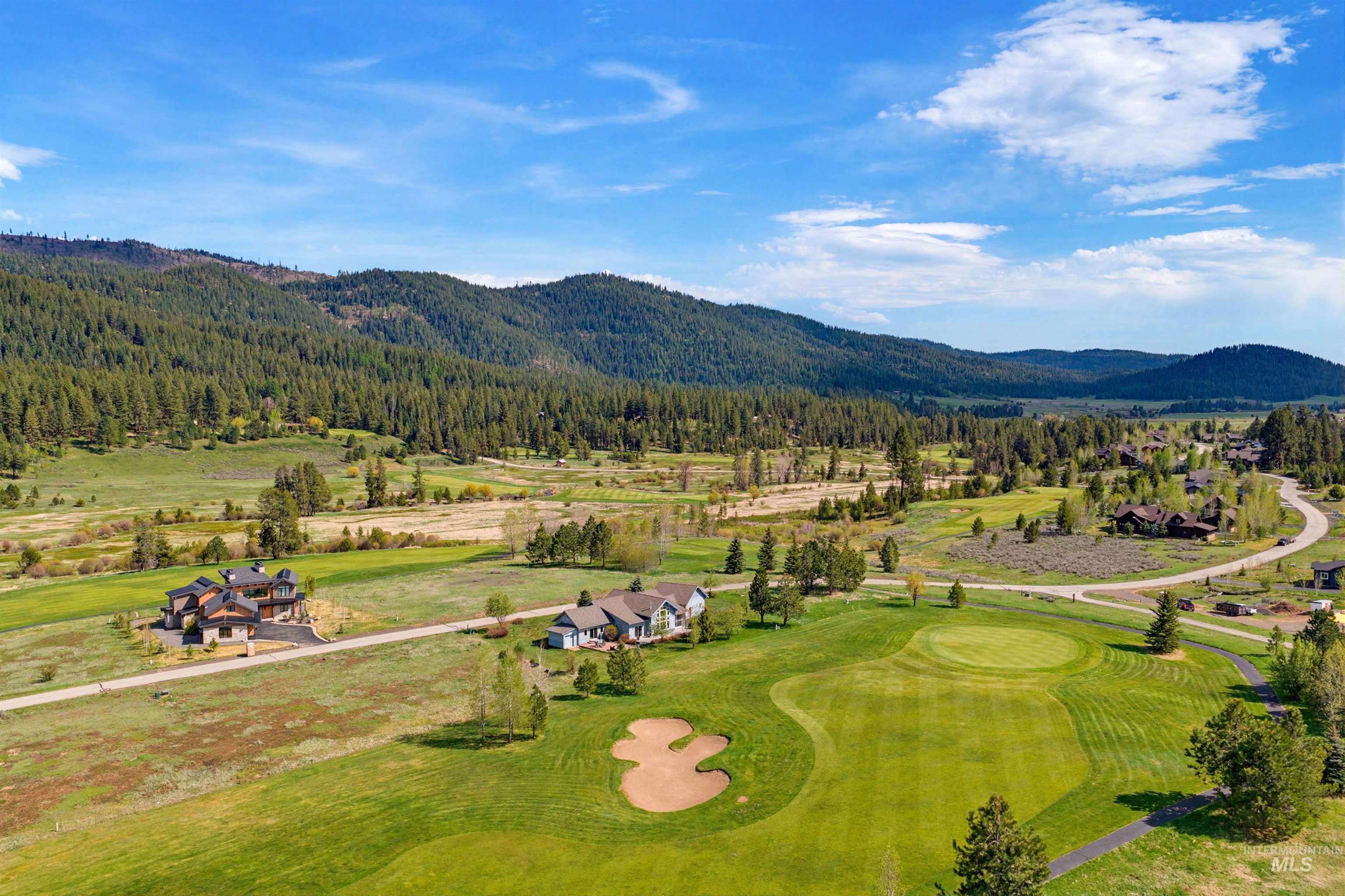 Expansive golf course property with a manicured green and sand trap