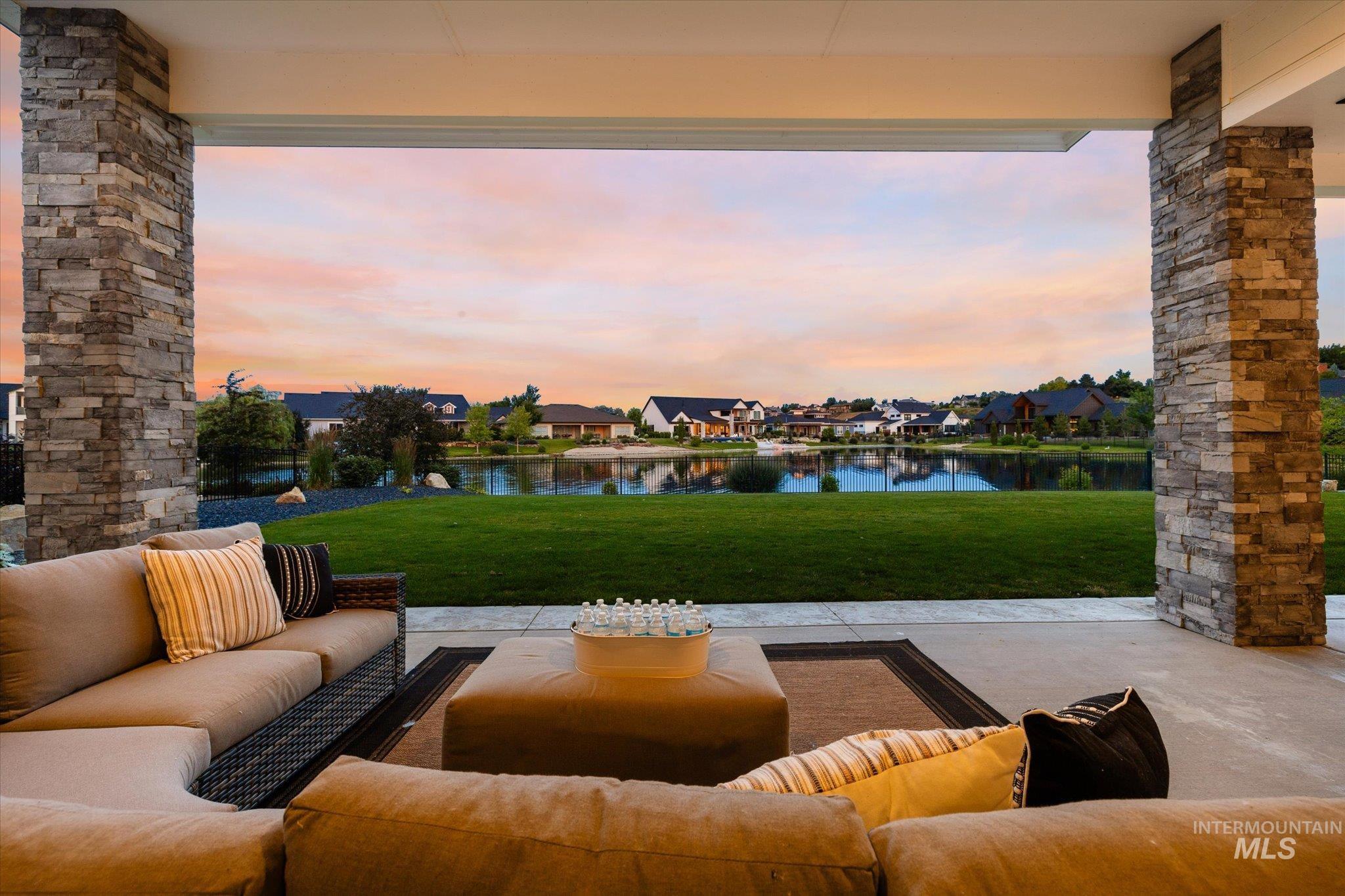 View of patio with an outdoor hangout area, a water view, and a residential view