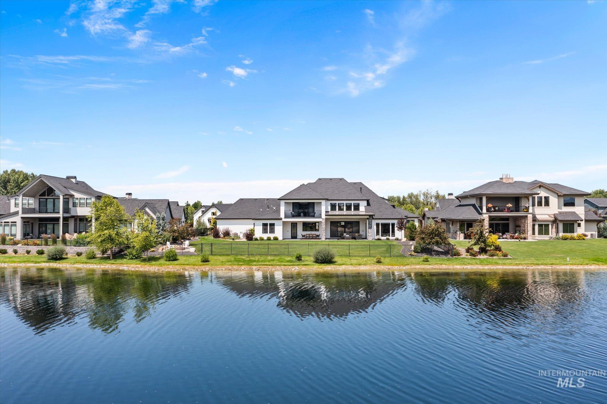 Water view featuring a fenced backyard and nearby suburban area