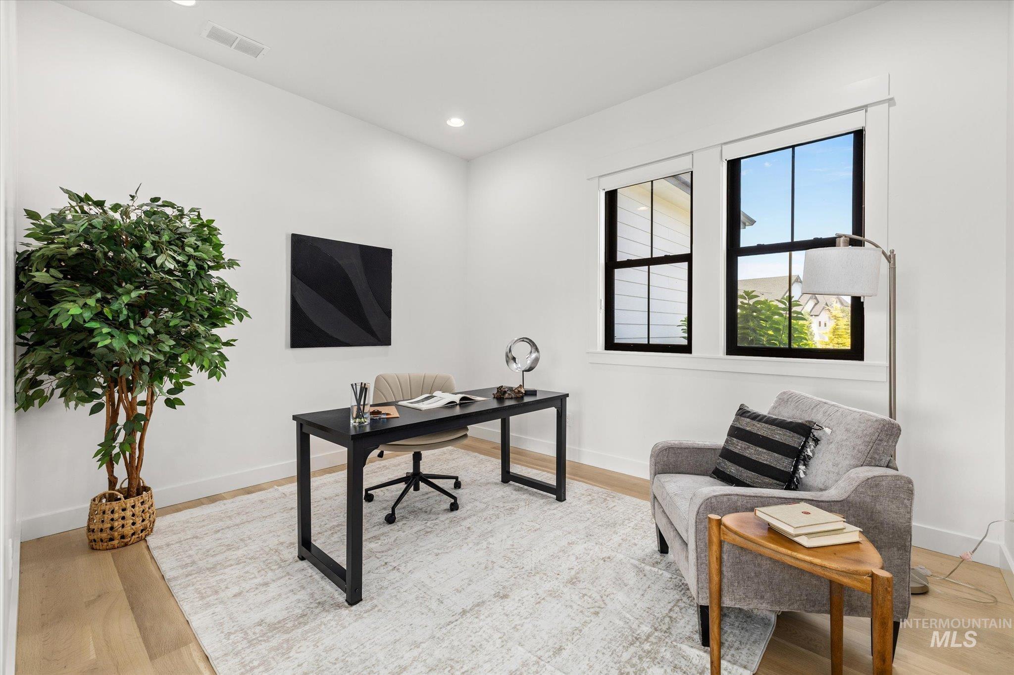 Office area with wood finished floors and recessed lighting