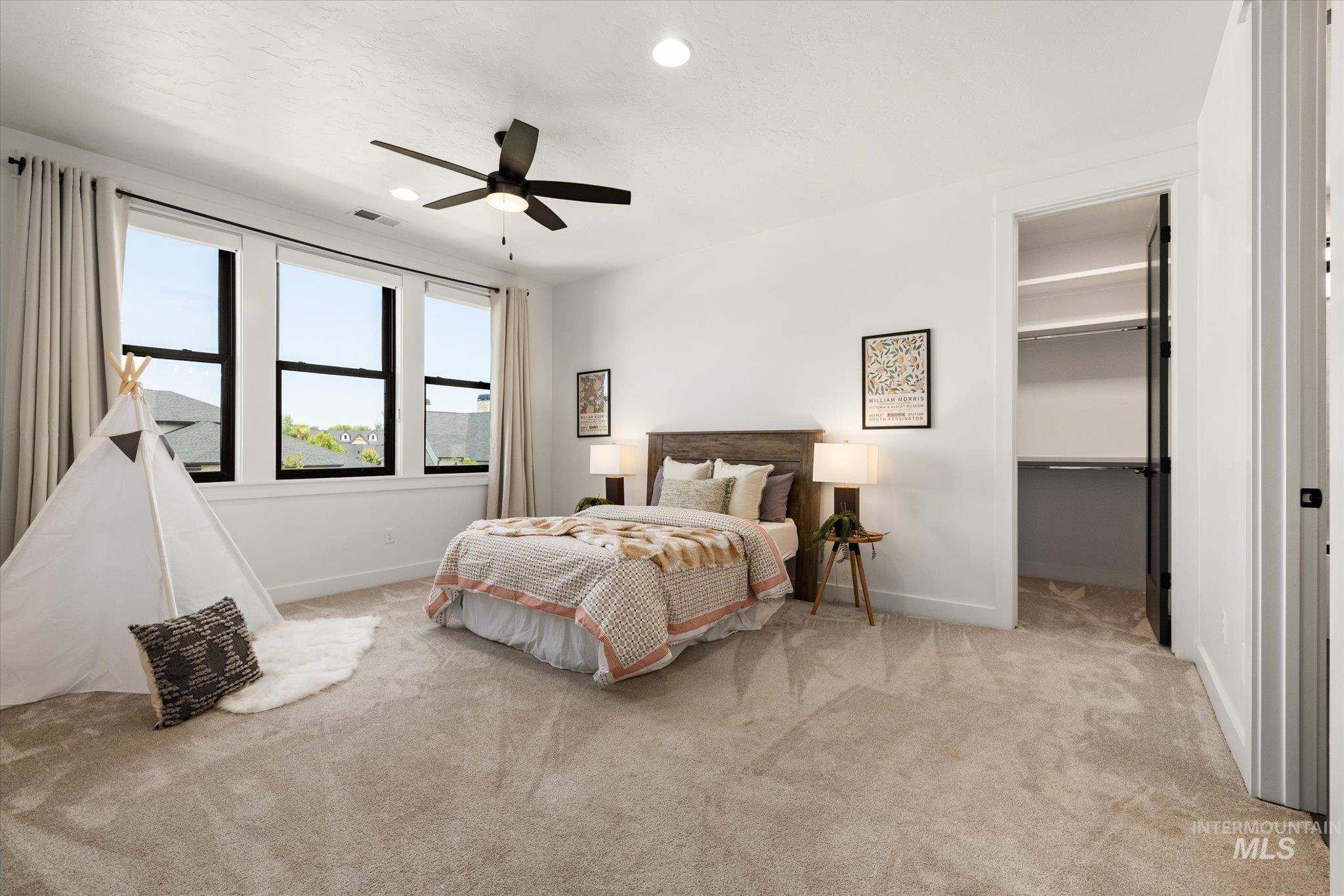 Bedroom featuring carpet floors, a walk in closet, ceiling fan, recessed lighting, and a closet