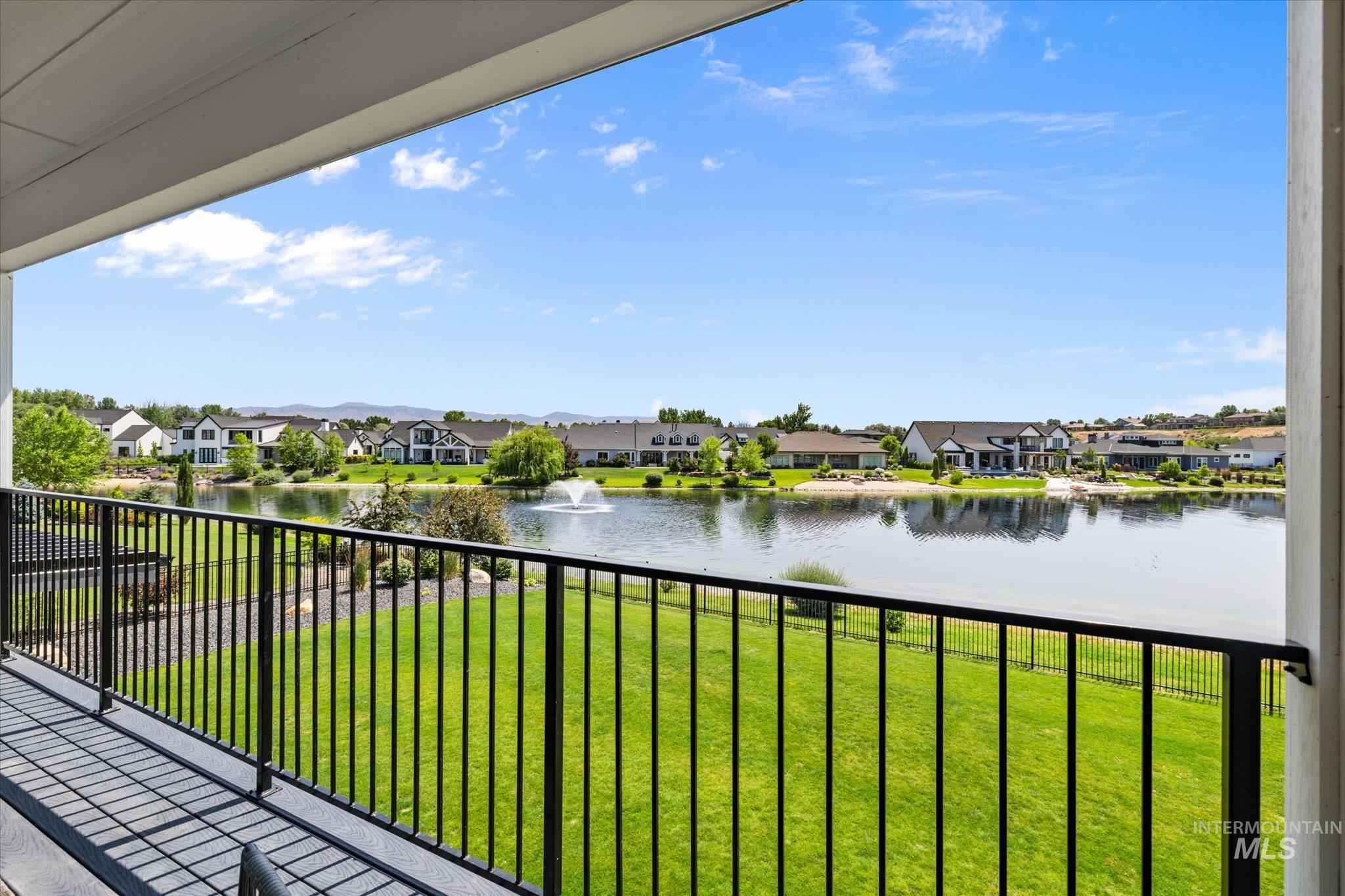Balcony featuring a residential view and a water view