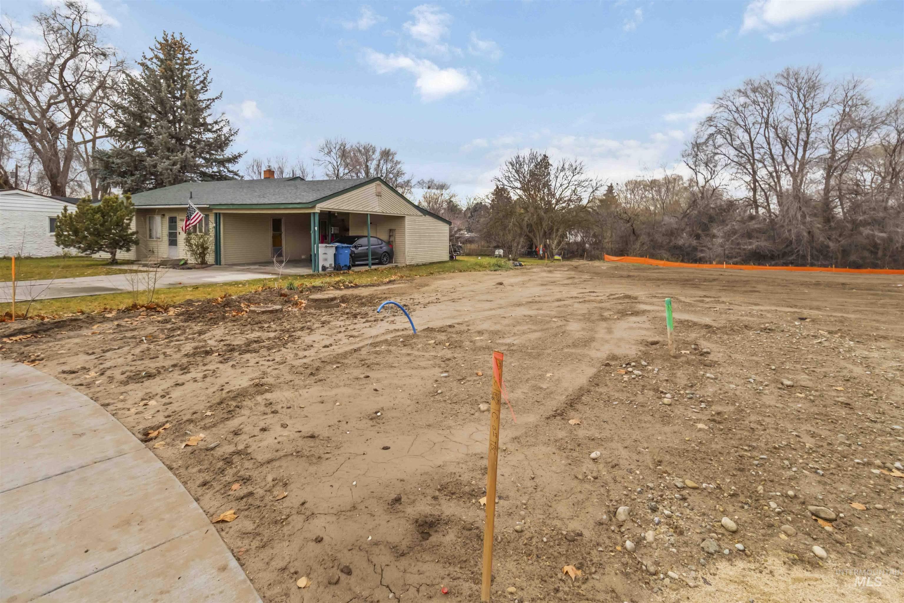 View of property's community featuring an attached carport and driveway