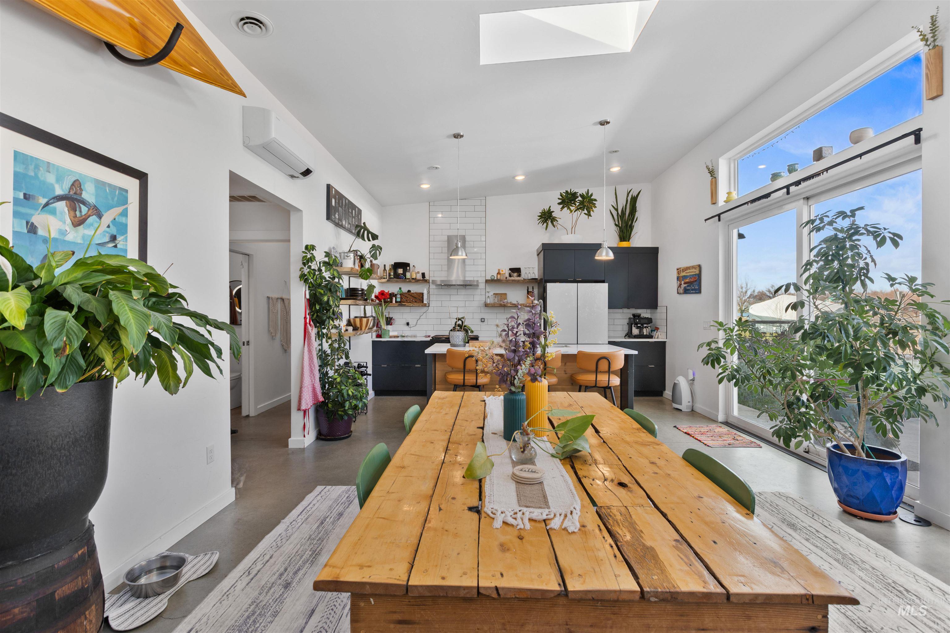Dining area with a skylight, vaulted ceiling, and recessed lighting