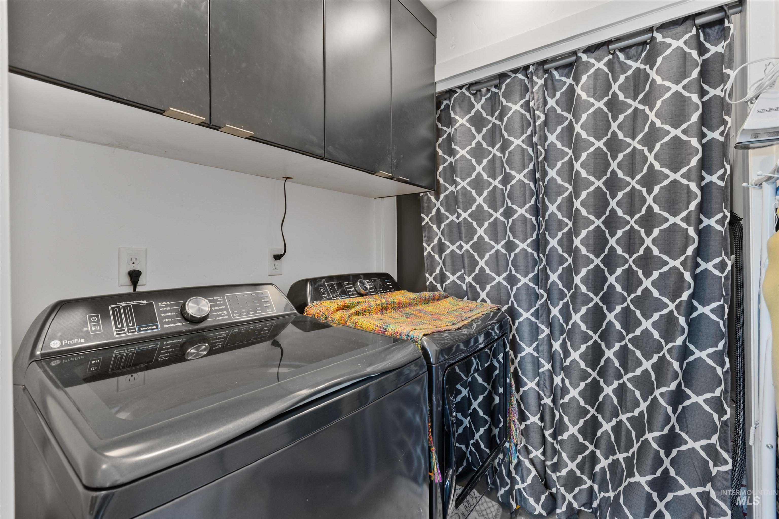 Laundry area featuring cabinet space and independent washer and dryer