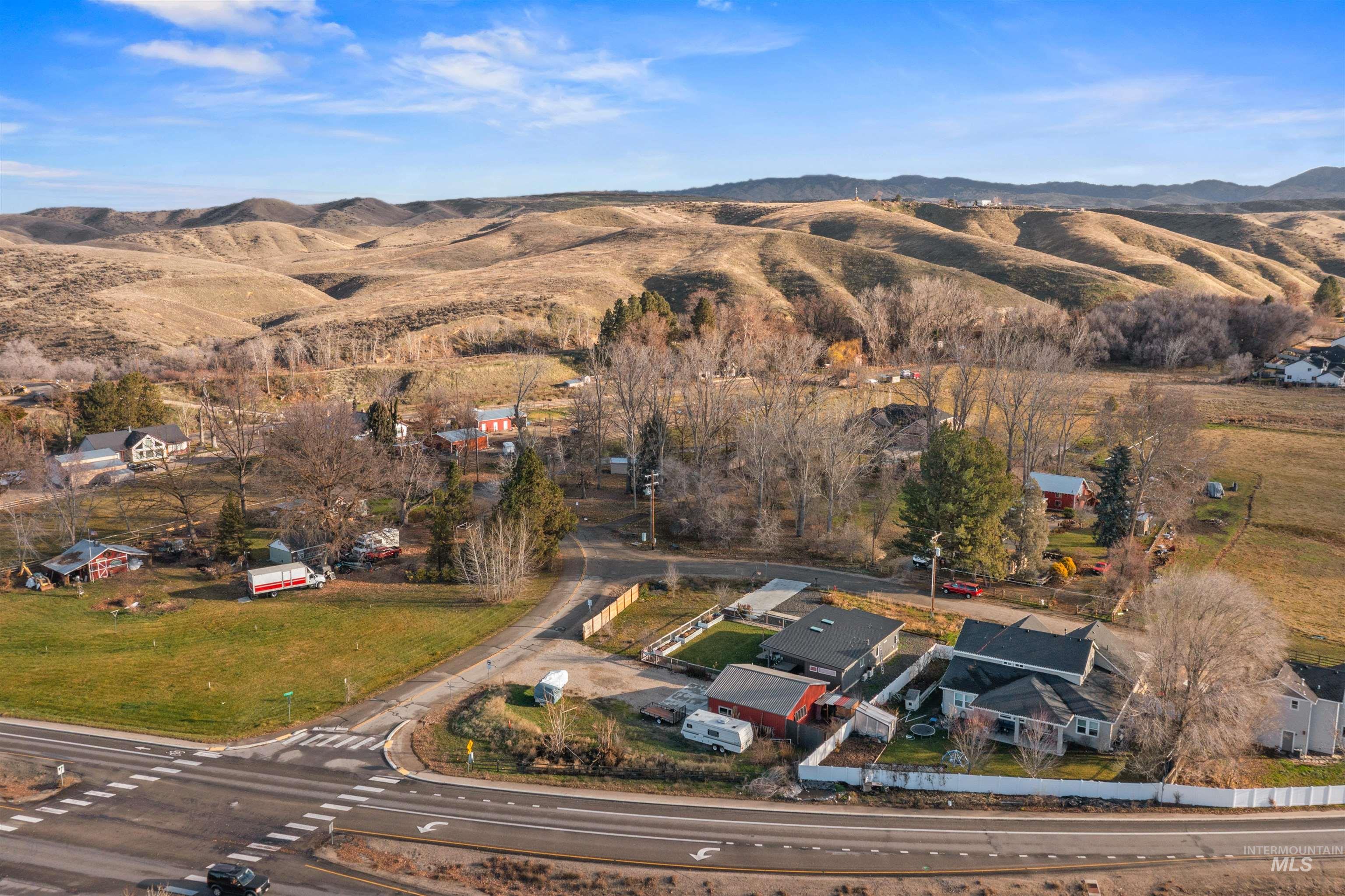 Aerial view of property and surrounding area with a mountain backdrop