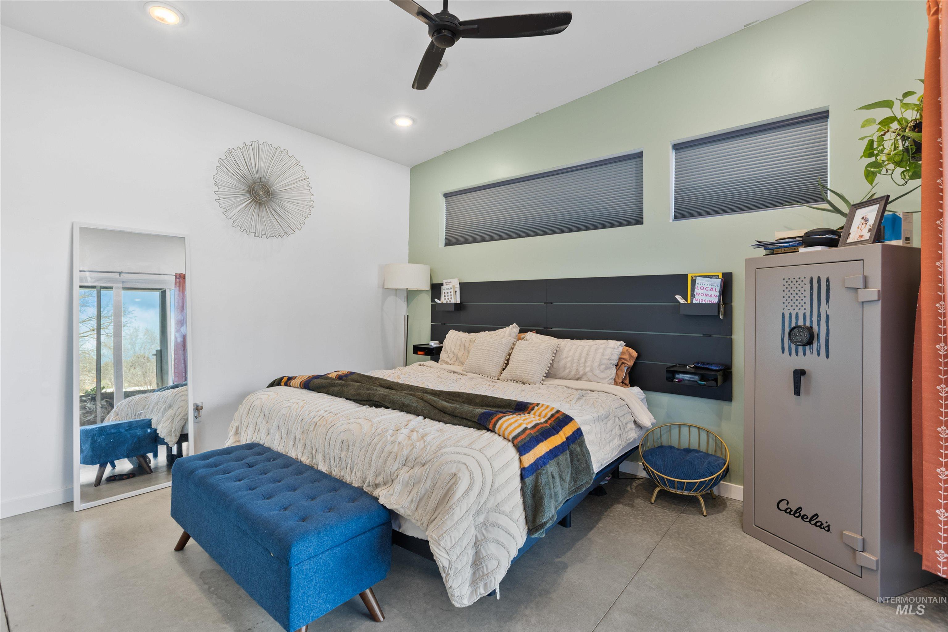 Bedroom featuring vaulted ceiling, concrete flooring, a ceiling fan, access to exterior, and recessed lighting