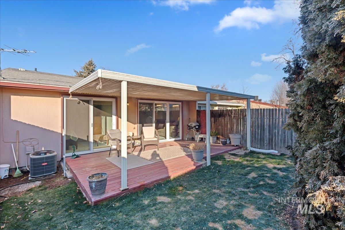 Rear view of property featuring a wooden deck
