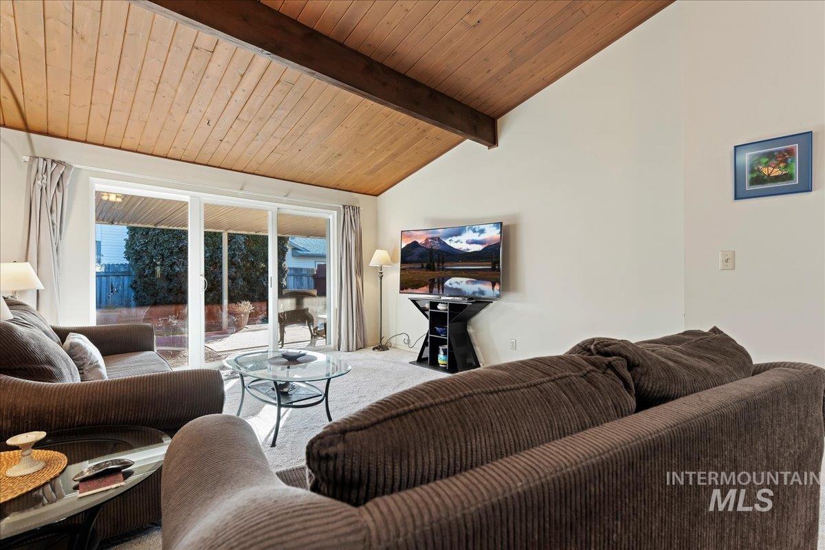 Living room featuring carpet floors and wooden ceiling