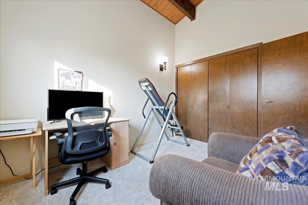 Office area featuring wood ceiling and light carpet