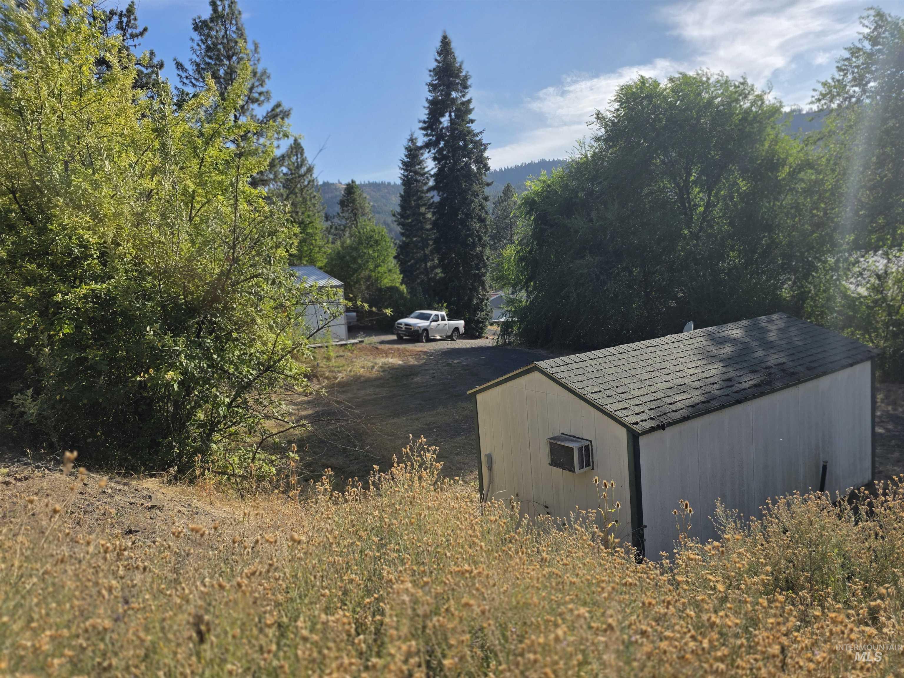 View of outdoor structure featuring a forest view