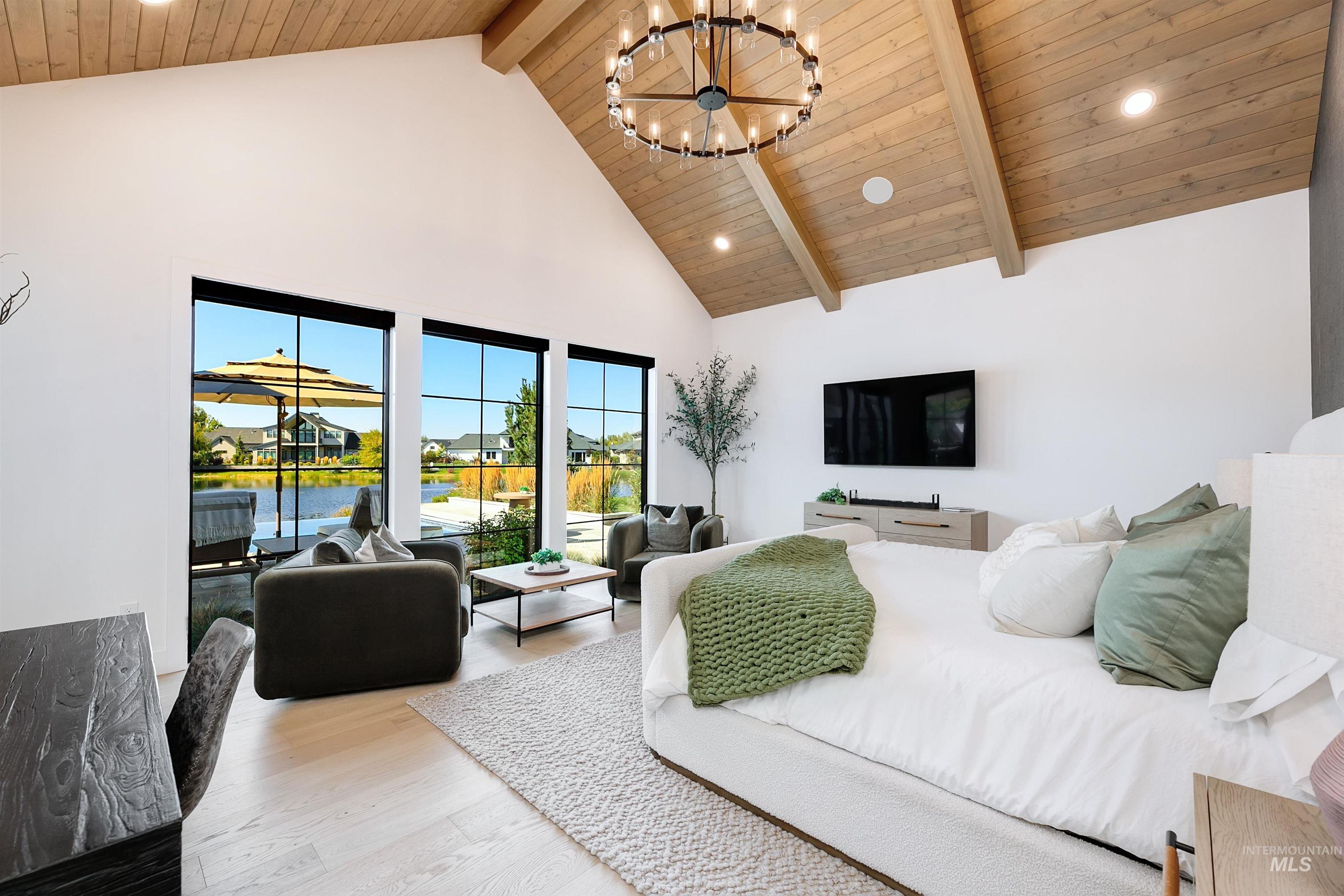 Bedroom featuring a wooden ceiling with exposed beams, light wood-style flooring, high vaulted ceiling, a chandelier, and recessed lighting