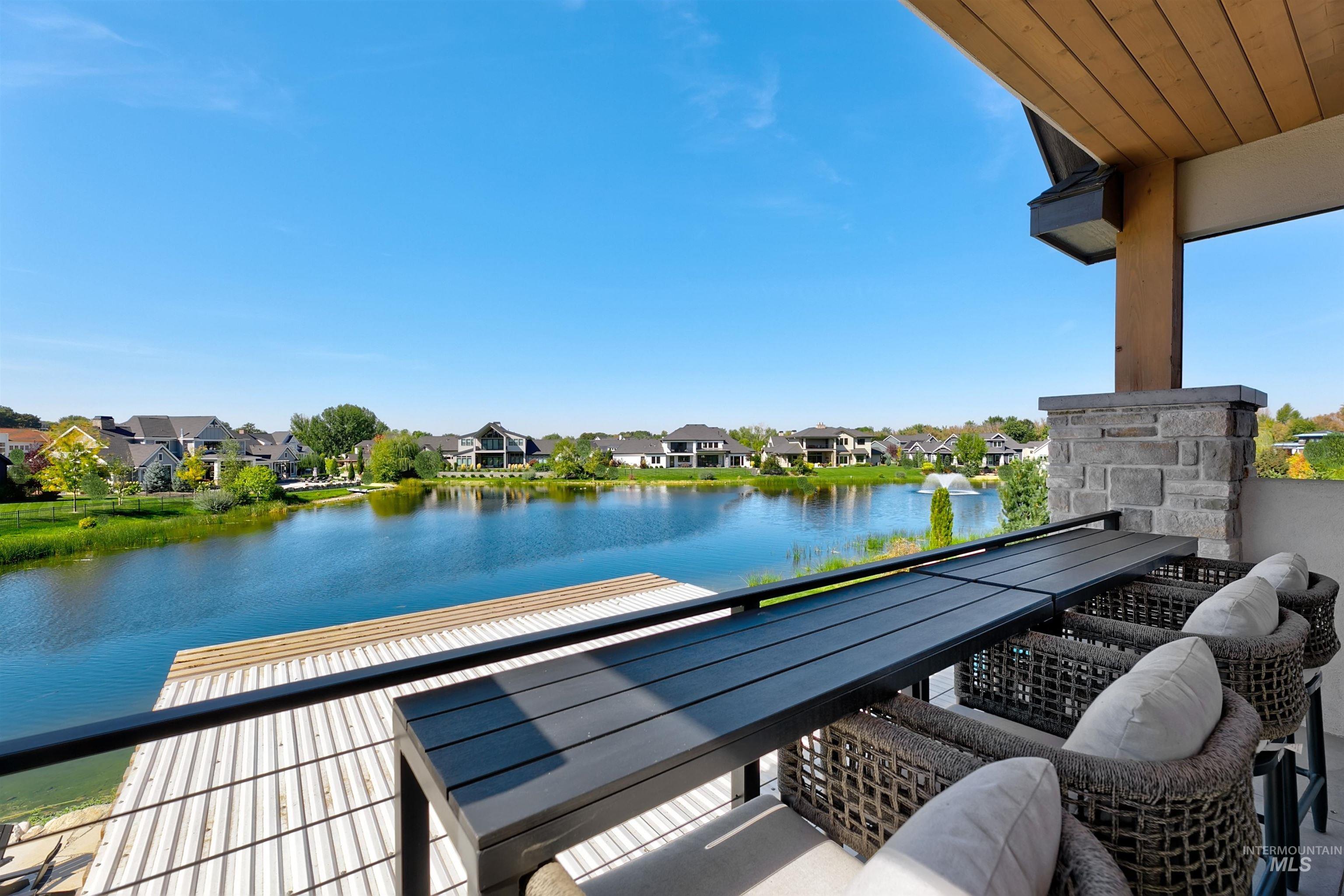Balcony featuring a water view and a residential view