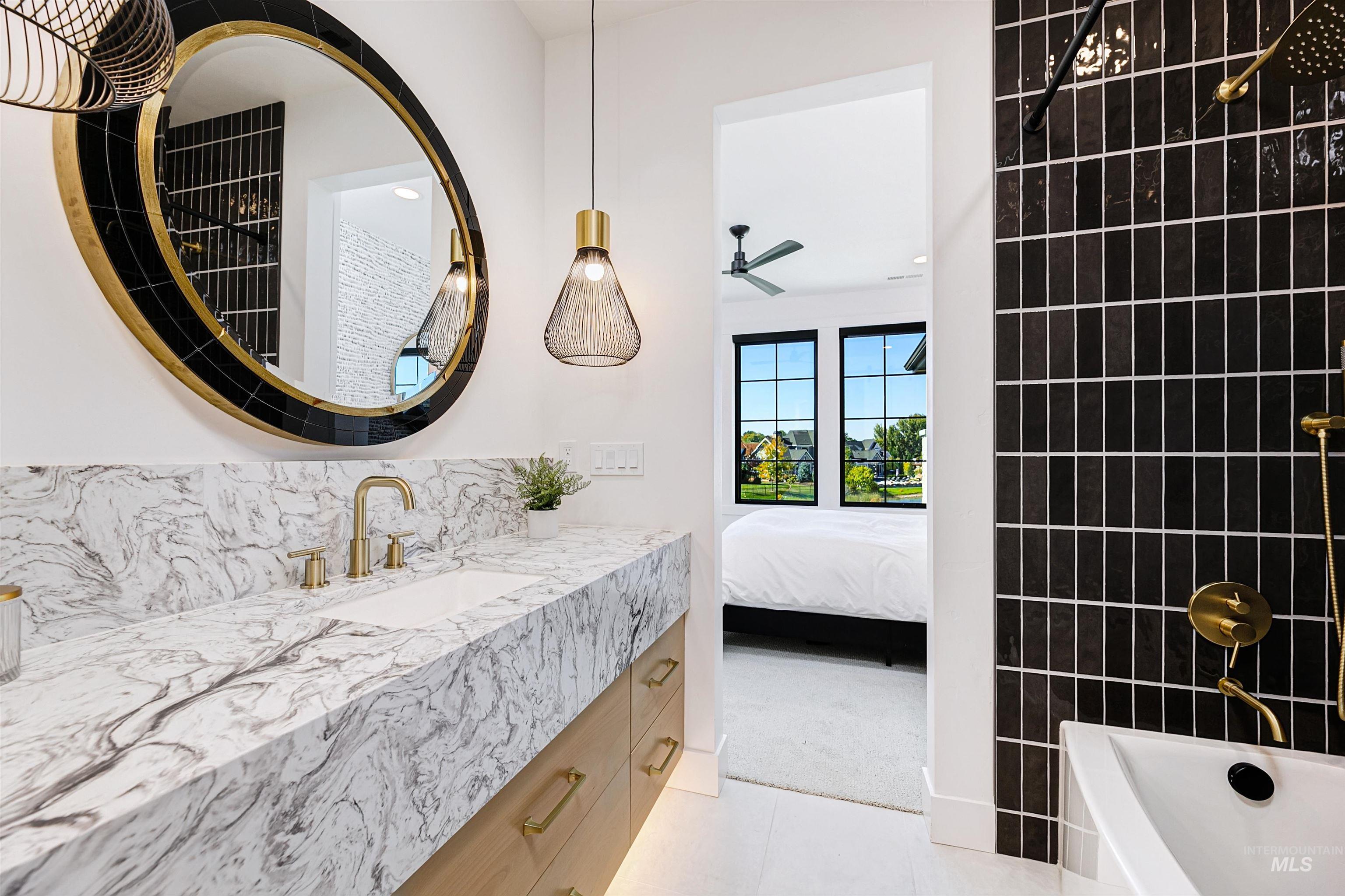 Full bathroom with vanity, light tile patterned floors, ensuite bath, shower / washtub combination, and backsplash