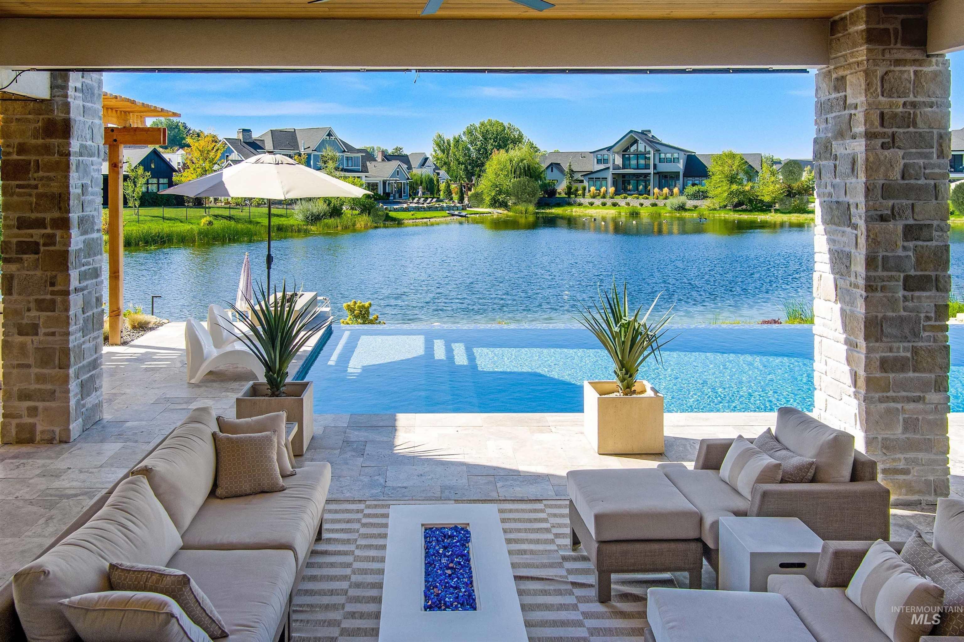 View of pool with a water view, a patio area, outdoor lounge area, and a residential view