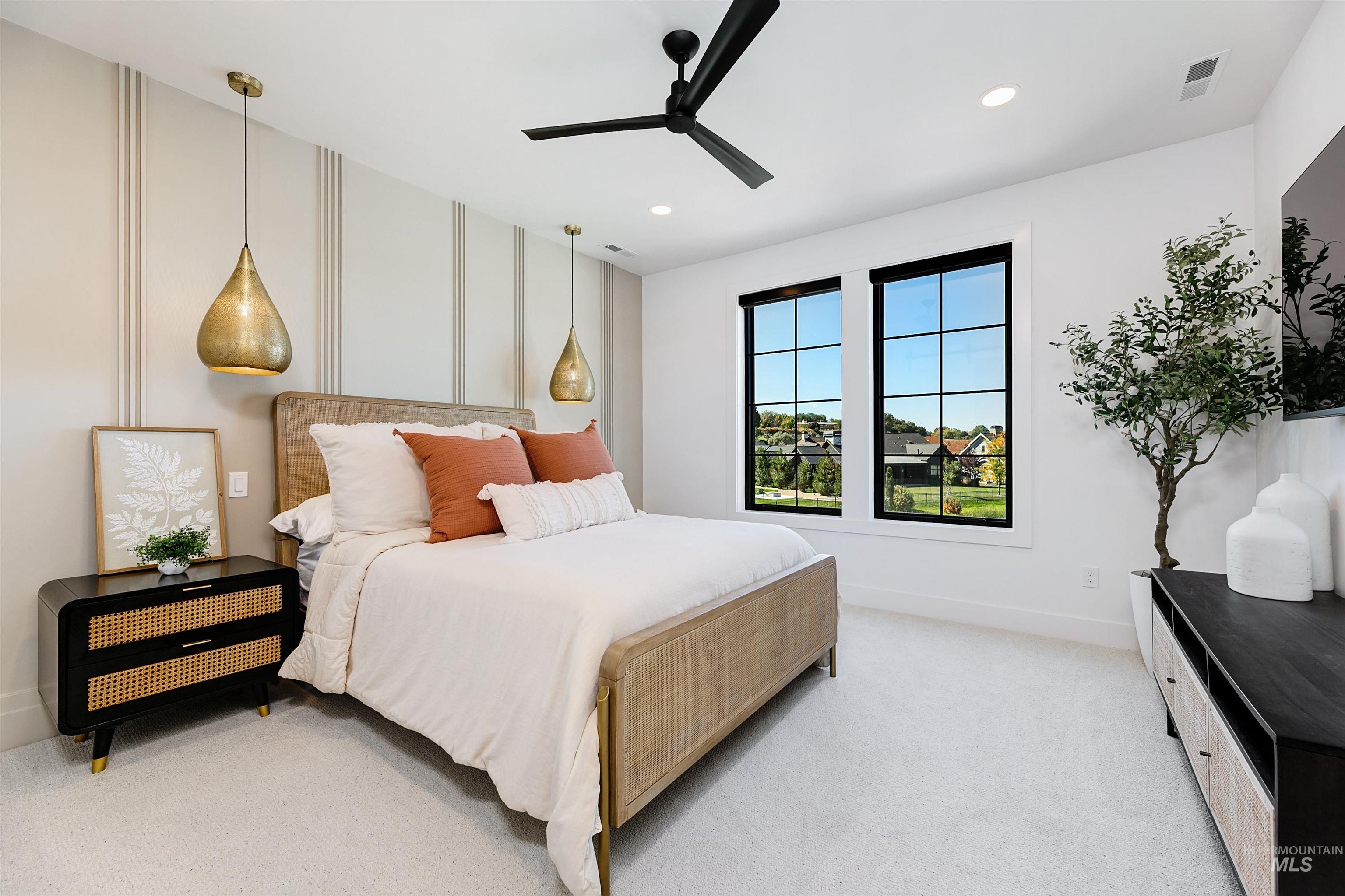 Bedroom featuring light carpet, ceiling fan, and recessed lighting