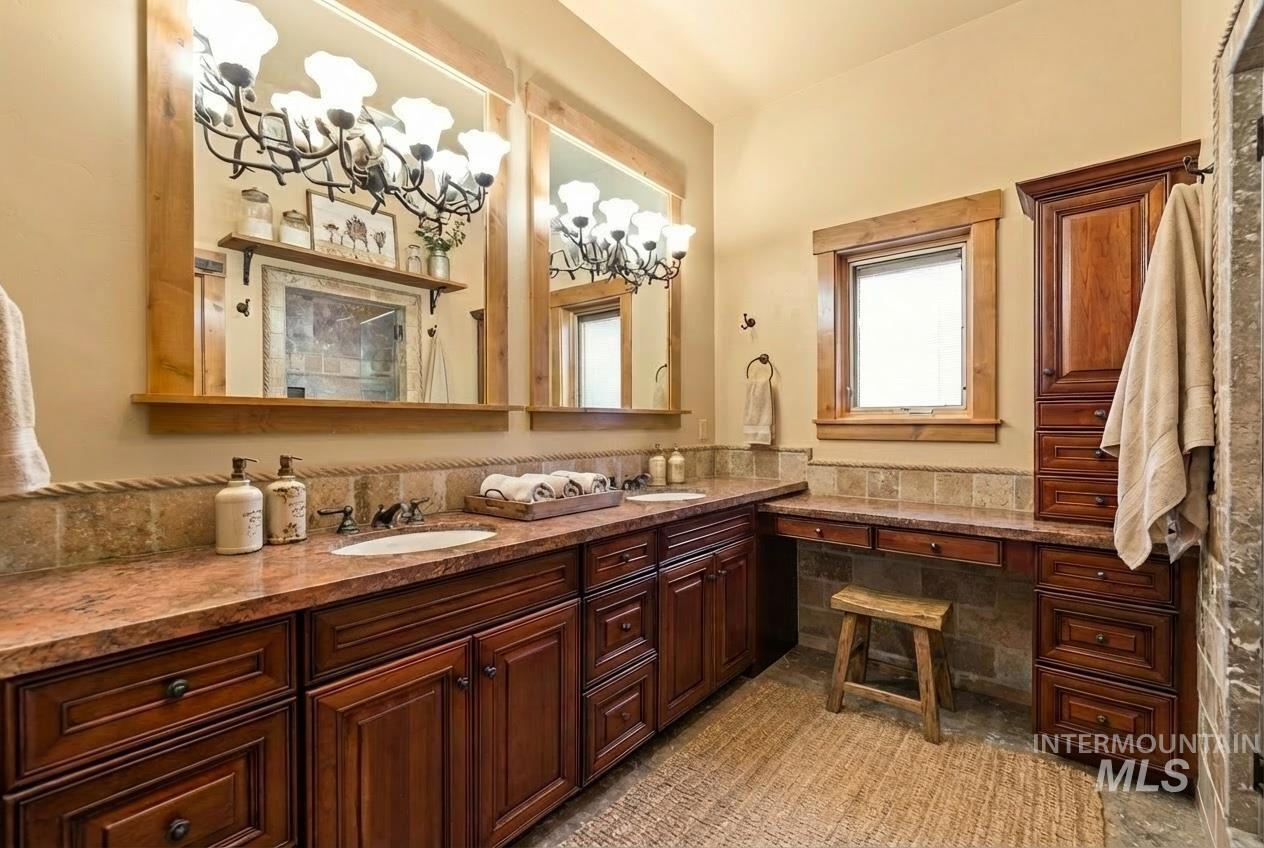 Bathroom featuring double vanity and a chandelier