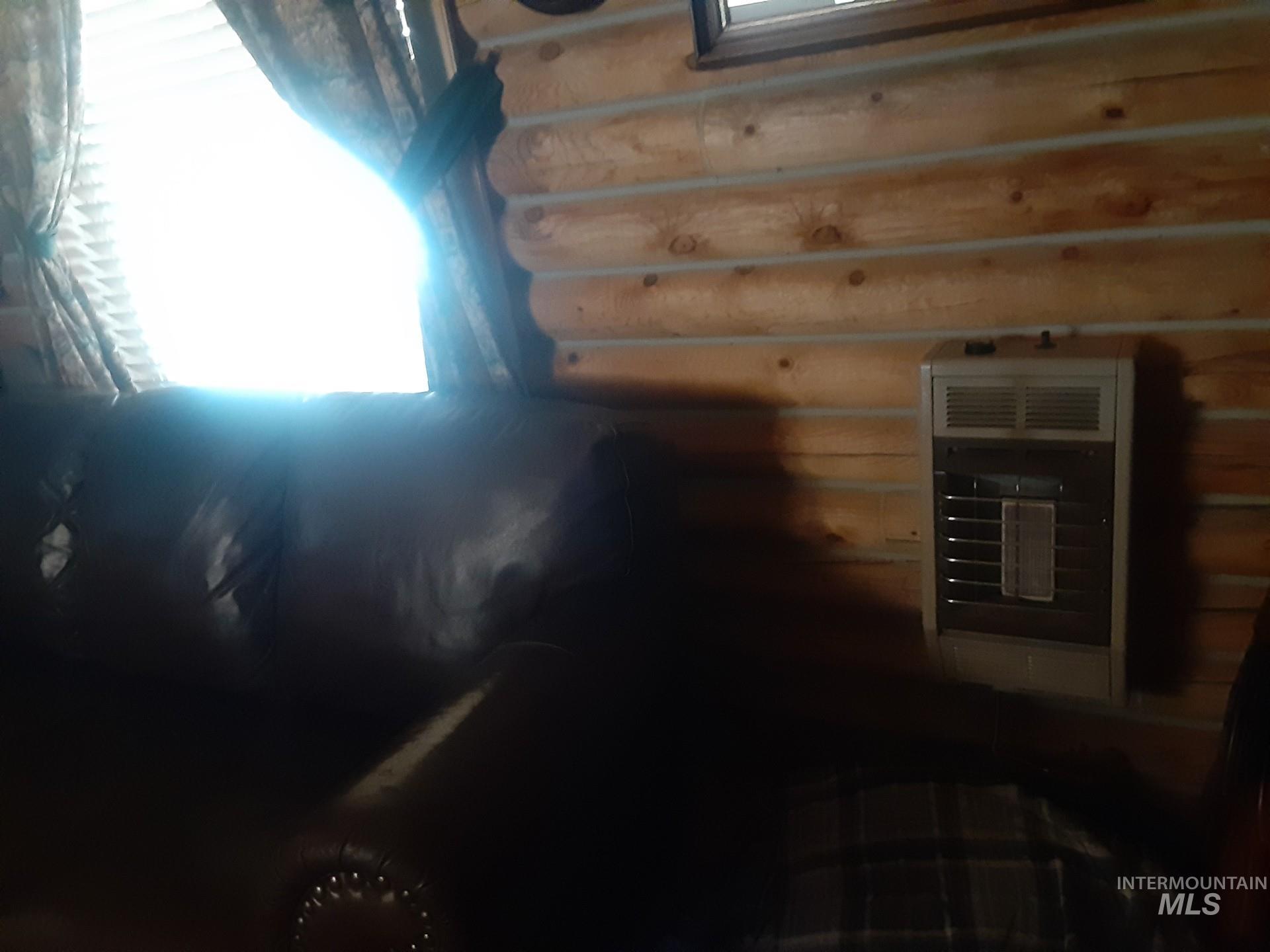 Sauna / steam room featuring log walls