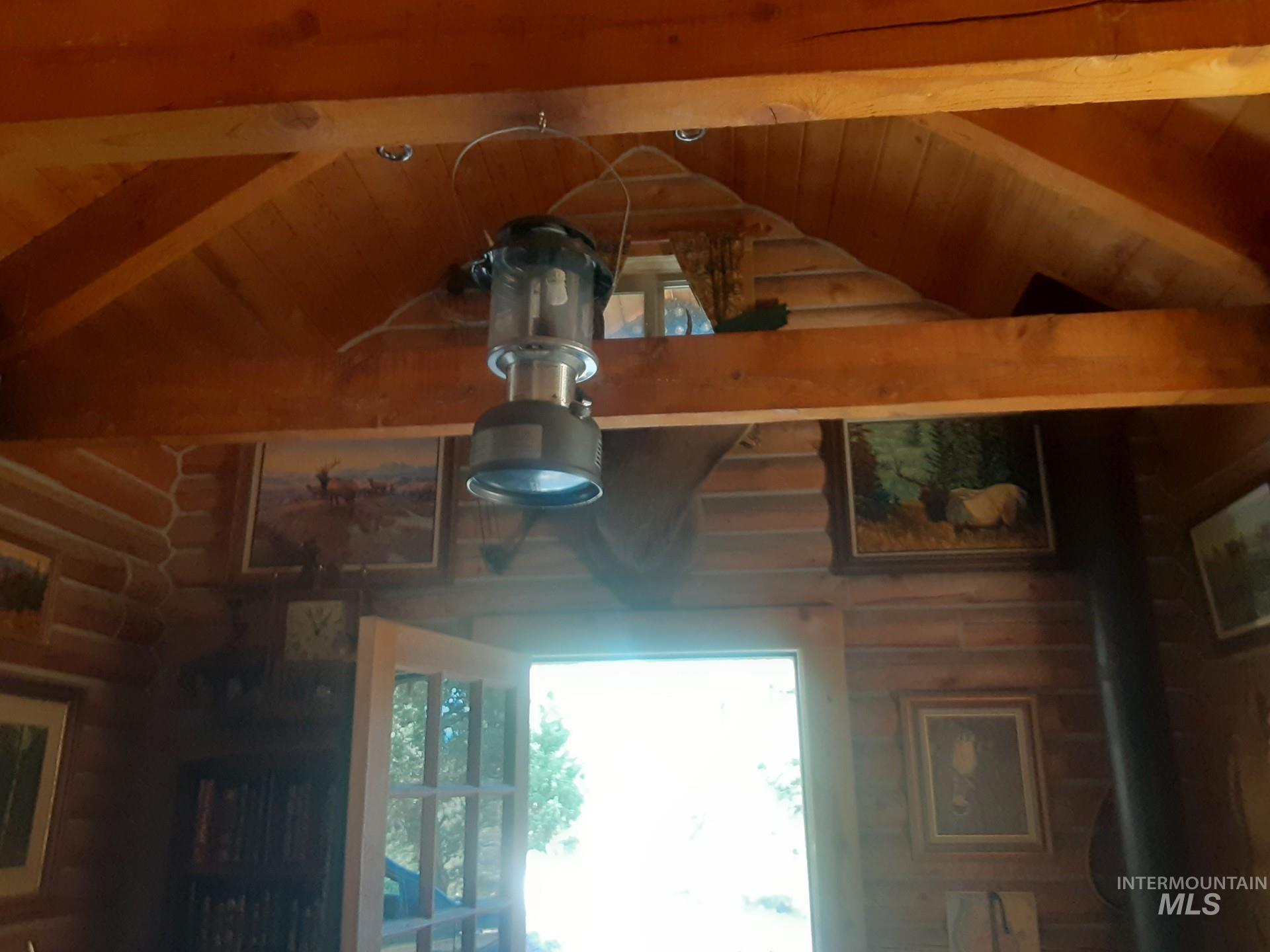 Detailed view of a wood ceiling with exposed beams and rustic walls