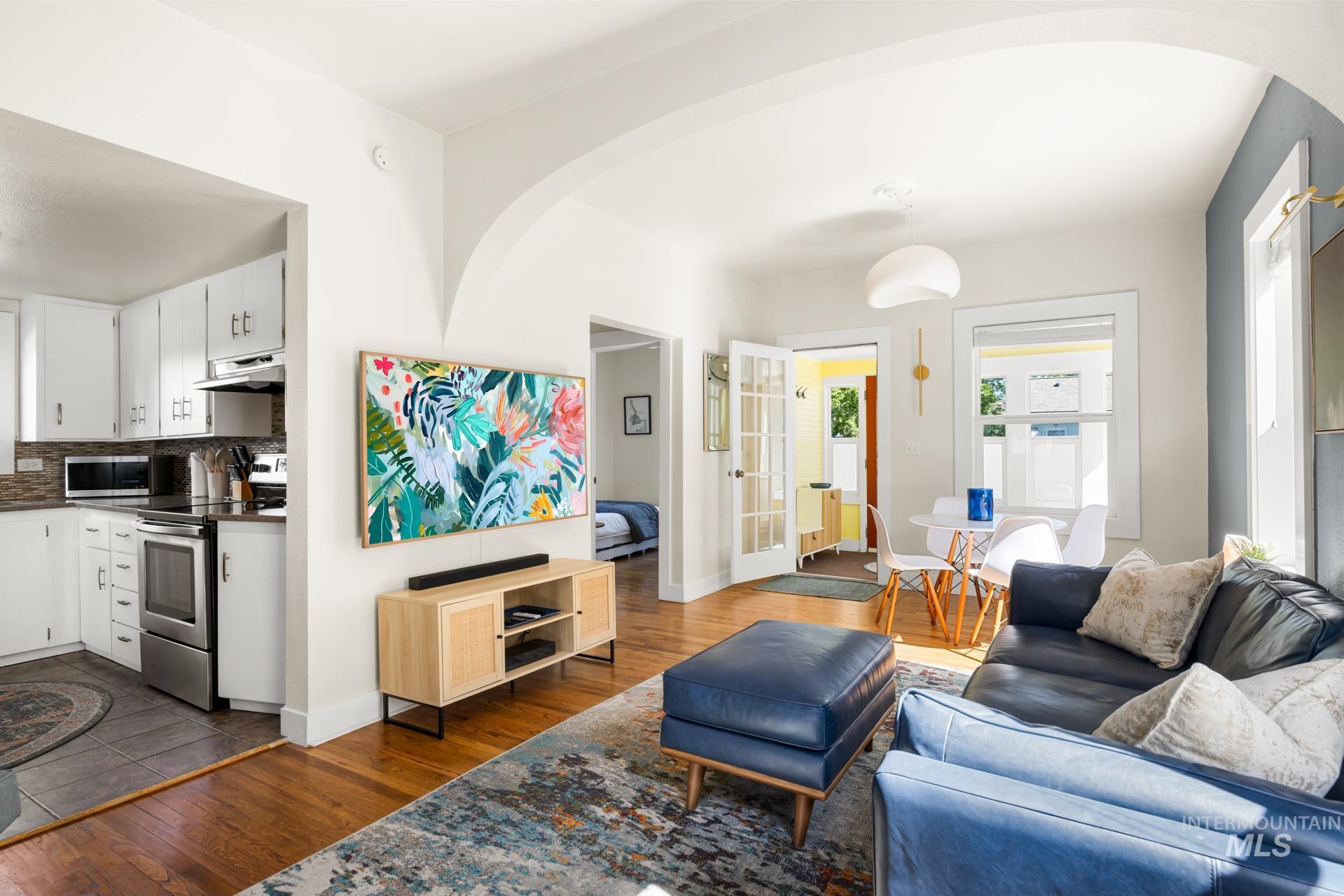 Open-concept living area featuring rich wood-finish flooring