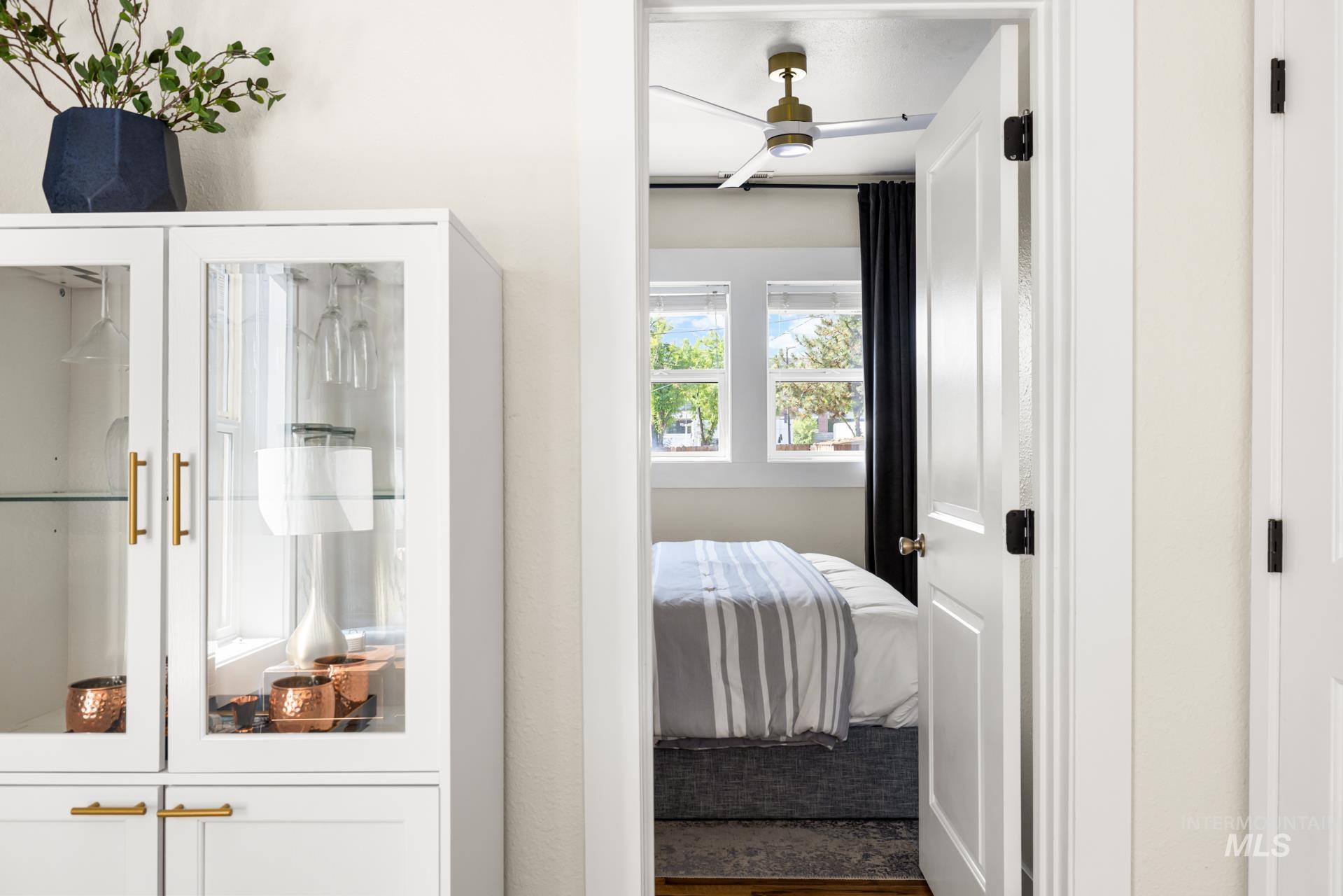 Built-in white cabinetry with glass display doors and gold-finish hardware