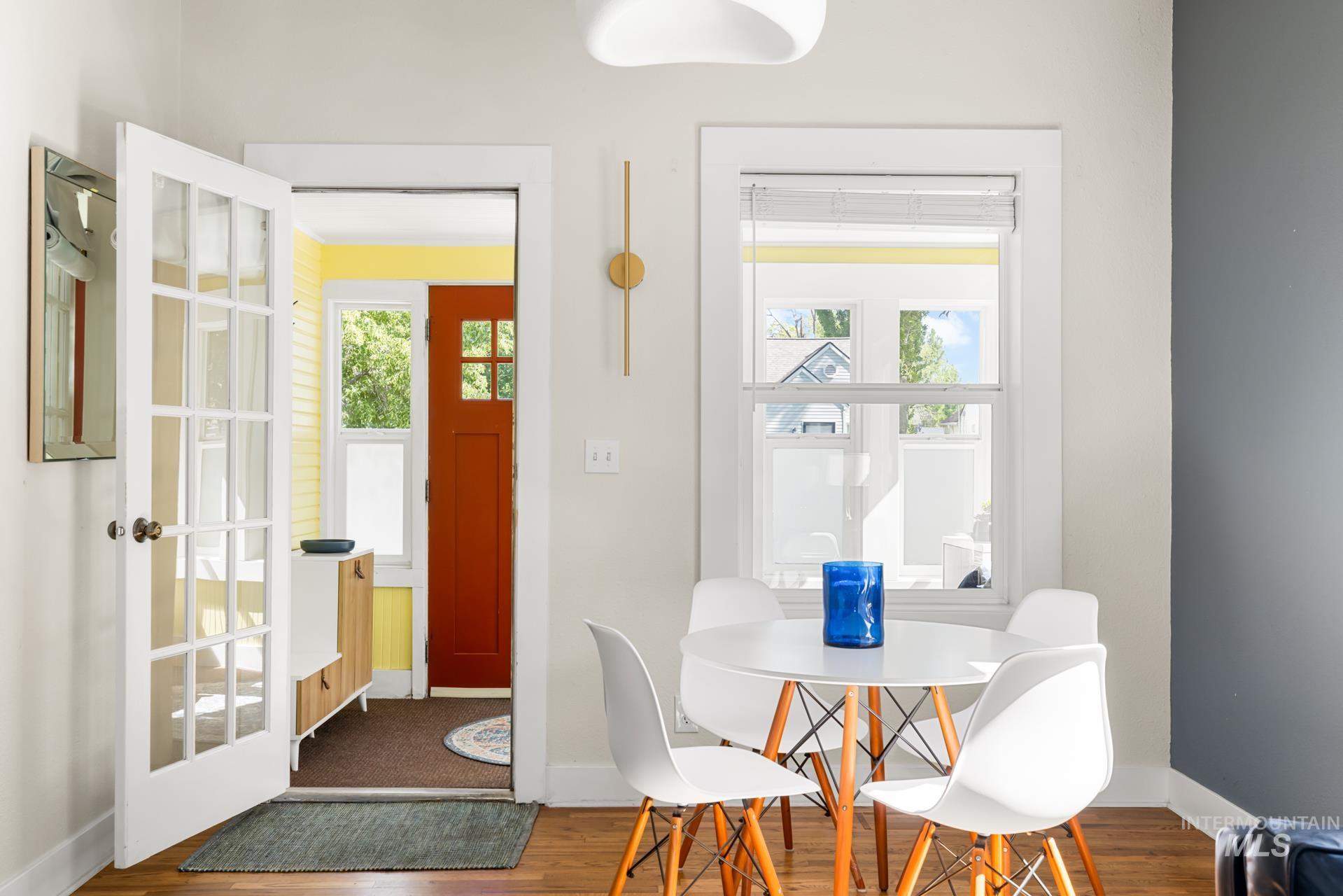 Hardwood flooring throughout, with a white French door entry